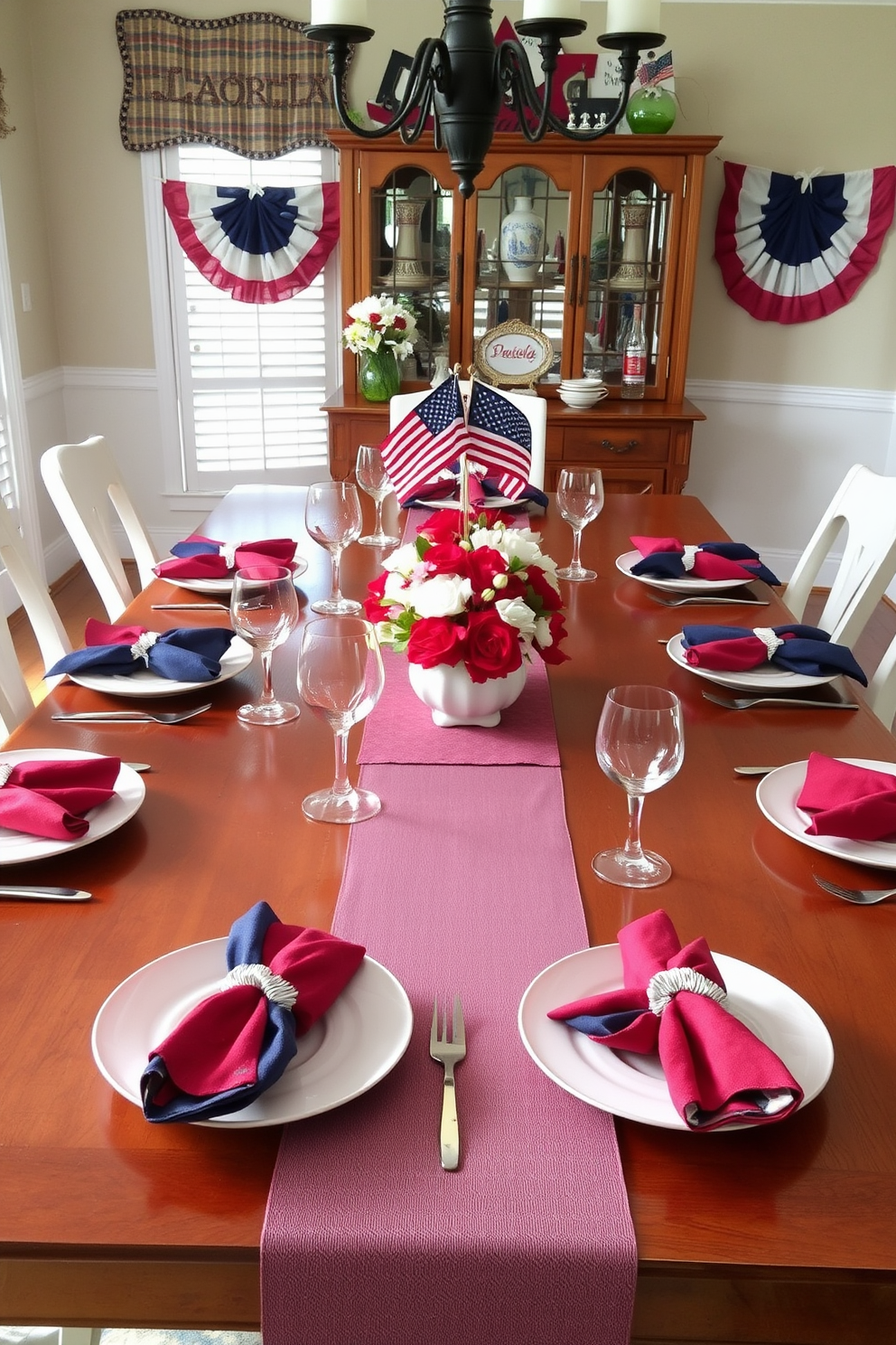 Chic white dinnerware is elegantly arranged on a polished wooden table. Colorful napkins are artfully folded and placed beside each plate, adding a vibrant touch to the setting. Labor Day decorations enhance the dining room with a festive atmosphere. Subtle red, white, and blue accents are incorporated through centerpieces and table runners, celebrating the holiday in style.