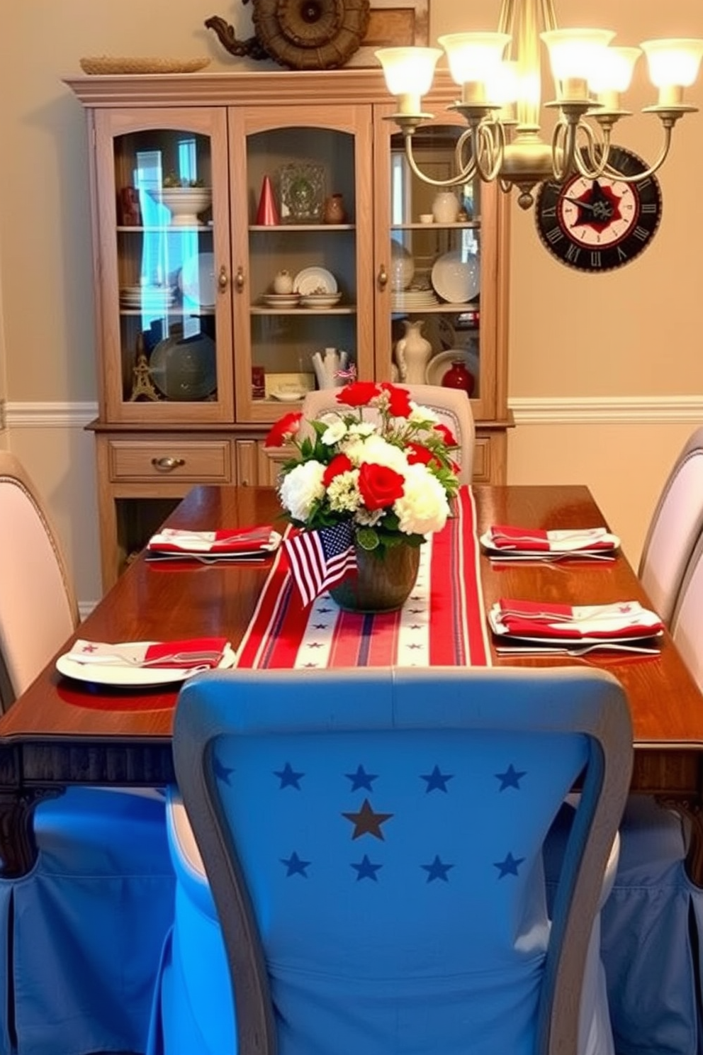 A patriotic table runner featuring stars runs down the center of a beautifully set dining table. Surrounding the table are elegant chairs with soft blue upholstery, complemented by red and white decorative accents. The dining room is adorned with subtle touches of Americana, including a centerpiece of fresh flowers in a rustic vase. Soft lighting from a chandelier casts a warm glow over the scene, creating a welcoming atmosphere for Labor Day celebrations.