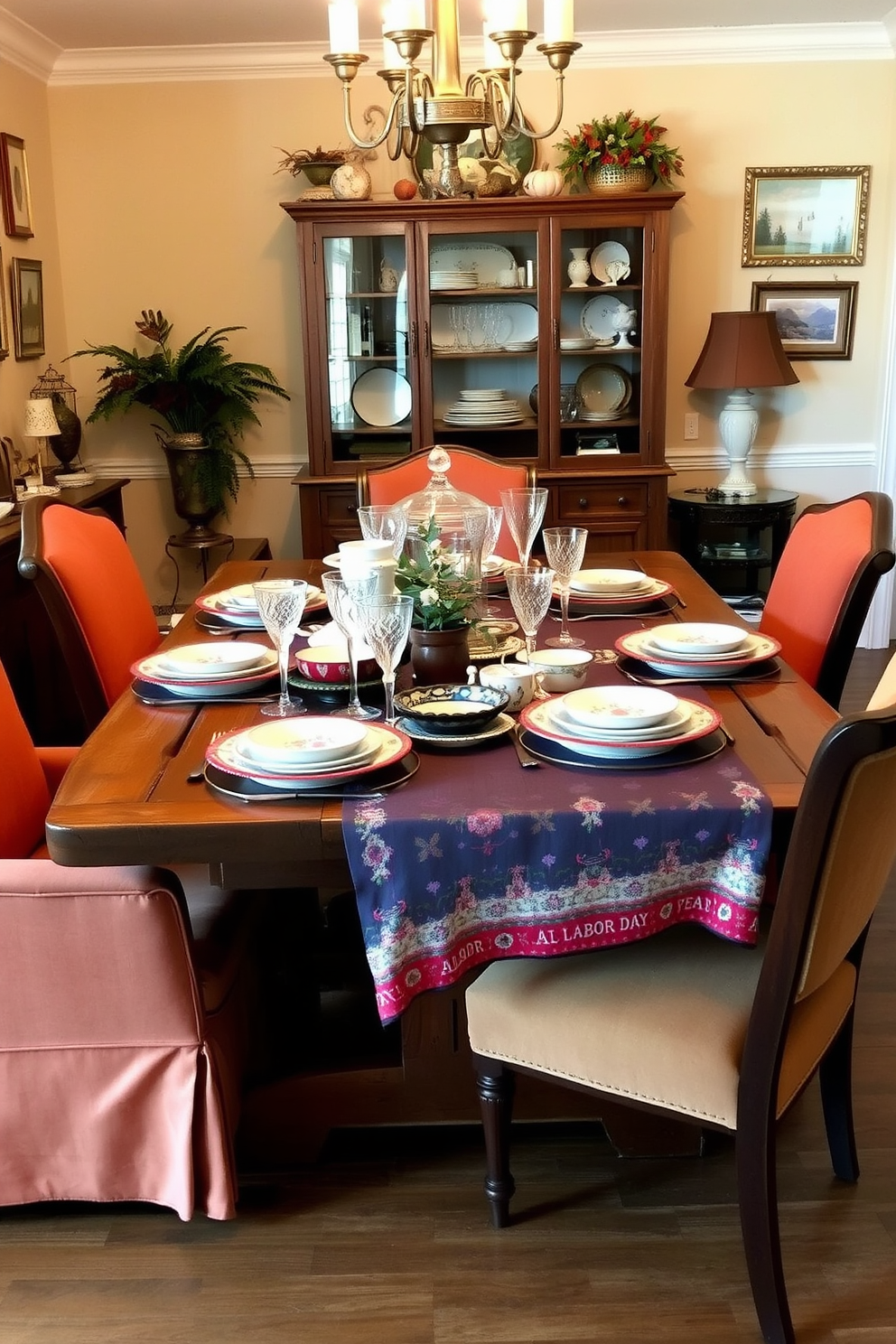 A charming dining room setting featuring a rustic wooden table adorned with an array of vintage dishes and glassware. The table is set with mismatched plates, elegant crystal glasses, and a colorful tablecloth that adds a festive touch for Labor Day. Surrounding the table are upholstered chairs in warm tones that complement the vintage theme. The walls are decorated with framed artwork and seasonal decor, creating a welcoming atmosphere for family gatherings.