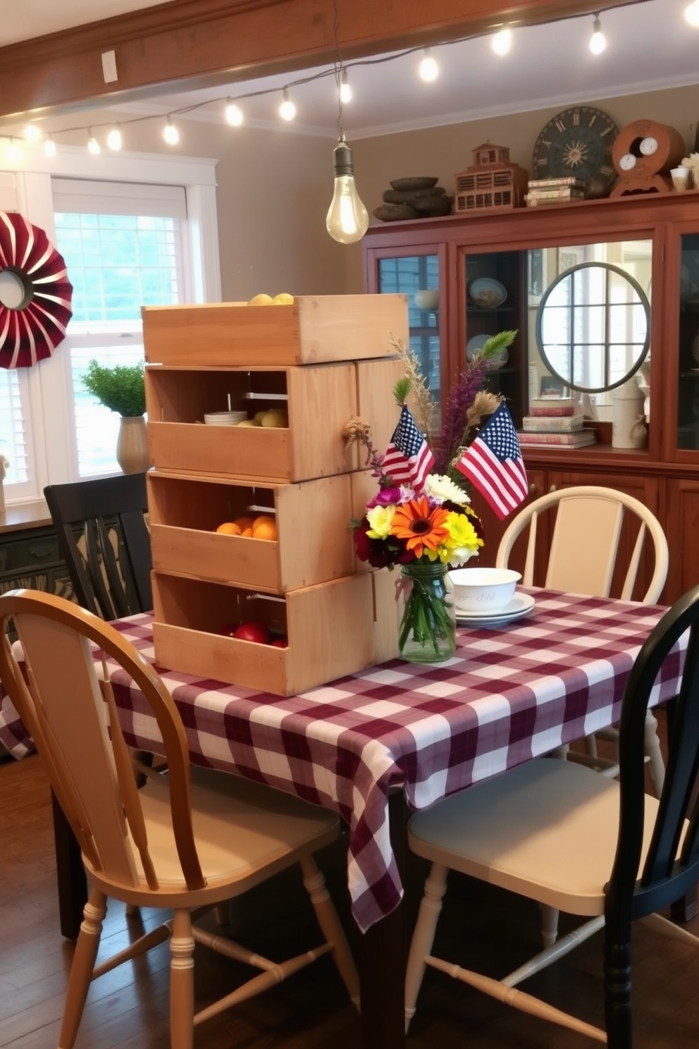 Rustic wooden crates are stacked creatively to serve as a charming food display at a festive dining table. The table is adorned with a plaid tablecloth and surrounded by mismatched chairs, creating a cozy and inviting atmosphere. For Labor Day, the dining room features a vibrant centerpiece of seasonal flowers arranged in a mason jar. String lights are draped overhead, adding a warm glow to the gathering space, perfect for celebrating with friends and family.