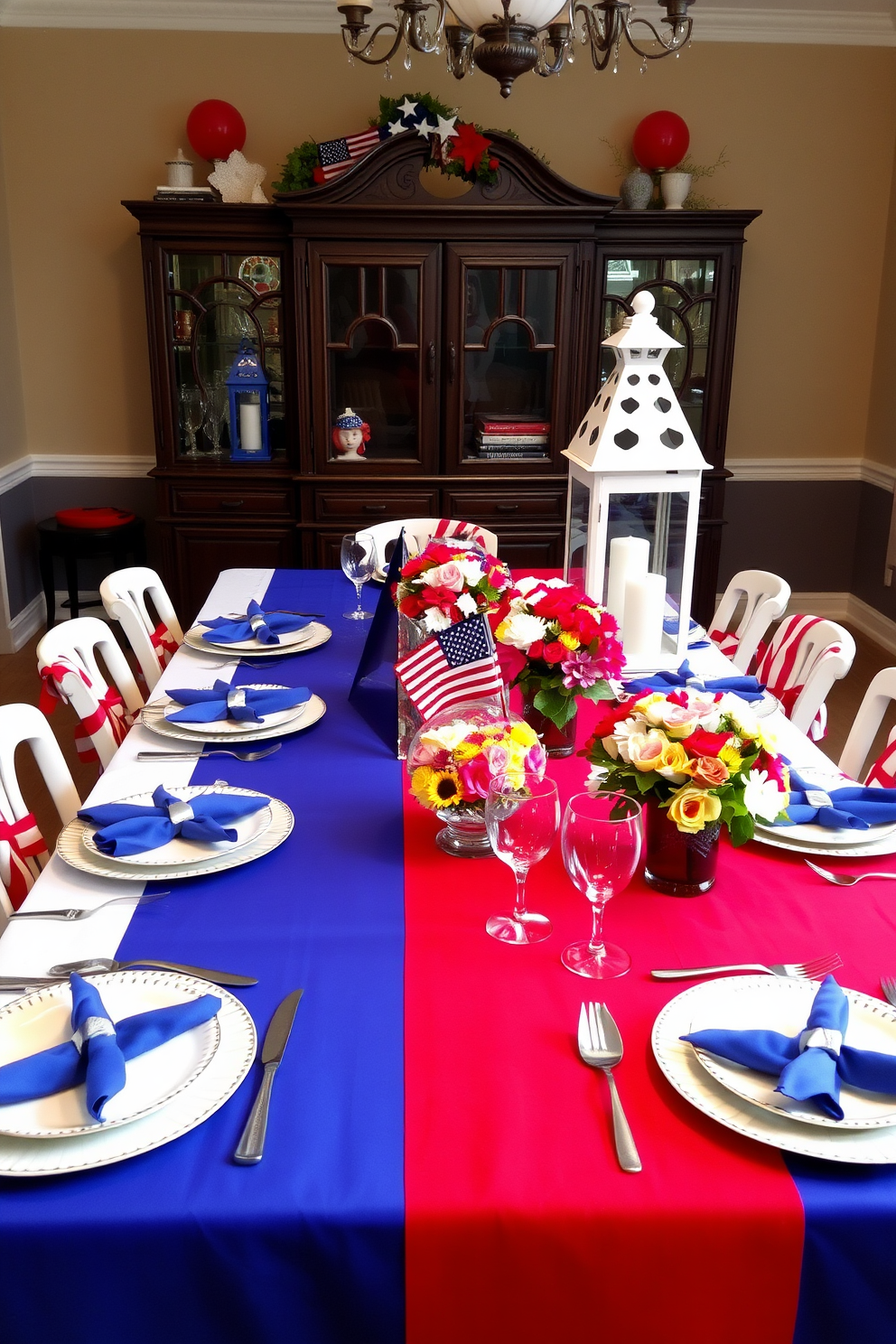 A festive dining room setting for Labor Day. The table is beautifully set with red white and blue tablecloths and matching dishes, complemented by vibrant floral centerpieces. Each place setting features elegant cutlery and napkins neatly folded in a star shape. Decorative lanterns in patriotic colors are placed along the table to create a warm and inviting atmosphere.