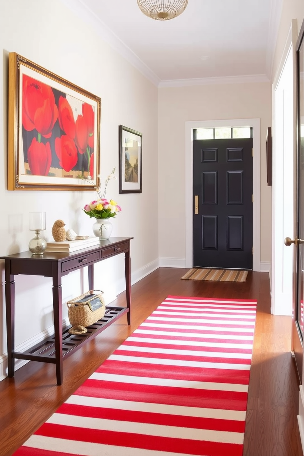 A vibrant entryway featuring a red and white striped runner rug that adds a pop of color to the space. The walls are adorned with framed artwork and a small console table holds decorative items and a fresh bouquet of flowers.