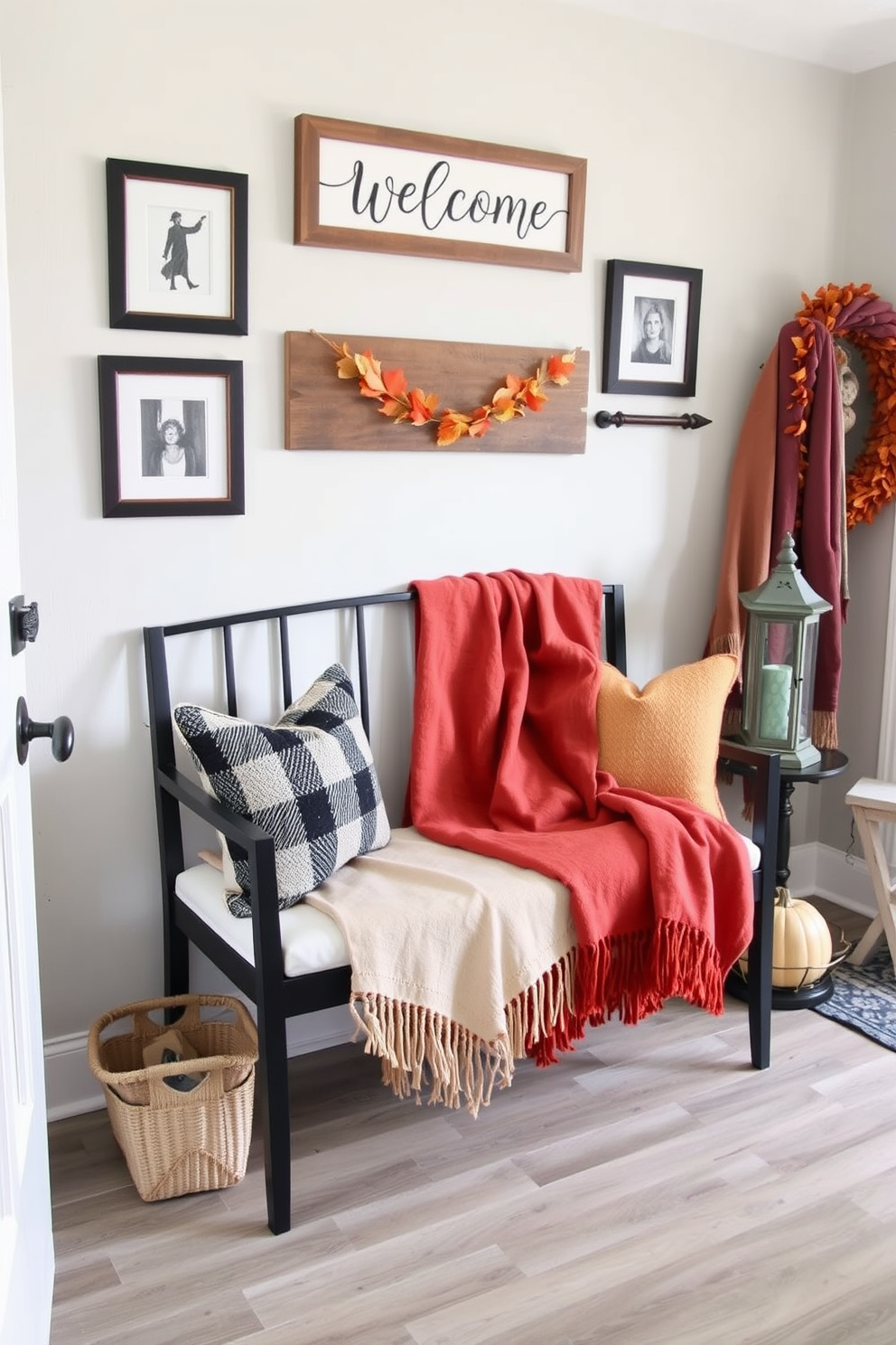 A cozy entryway featuring a stylish bench adorned with a seasonal throw blanket in warm autumn colors. The walls are decorated with framed art and a welcome sign, while a small table holds a pumpkin centerpiece and a rustic lantern.