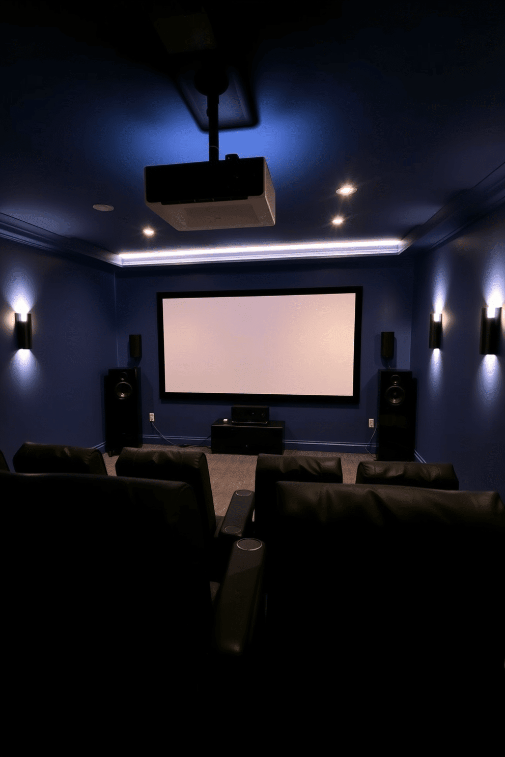 A cozy home theater setup designed for immersive audio experiences. The walls are painted in a deep navy blue, creating a cinematic atmosphere, while plush black recliners are arranged for optimal viewing. Surround sound speakers are strategically placed around the room to enhance audio quality. A sleek, modern projector screen descends from the ceiling, complemented by soft, dimmable lighting for the perfect movie night ambiance.