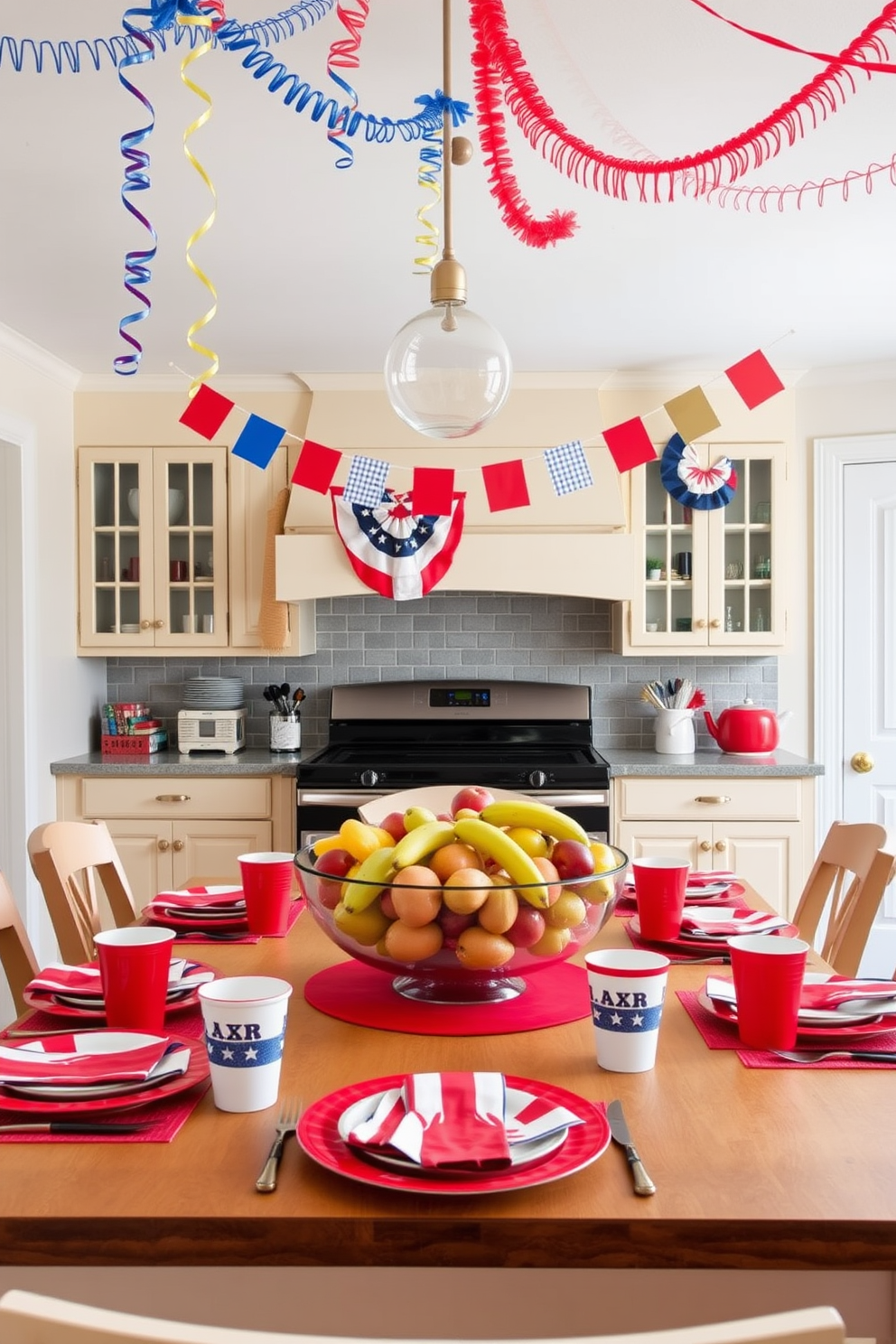 A festive kitchen setting adorned for Labor Day. The table is set with vibrant red, white, and blue dishware, featuring plates, cups, and napkins that celebrate the holiday spirit. Brightly colored decorations hang from the ceiling, including streamers and banners. A large bowl of fresh fruit sits at the center of the table, adding a touch of freshness to the festive atmosphere.