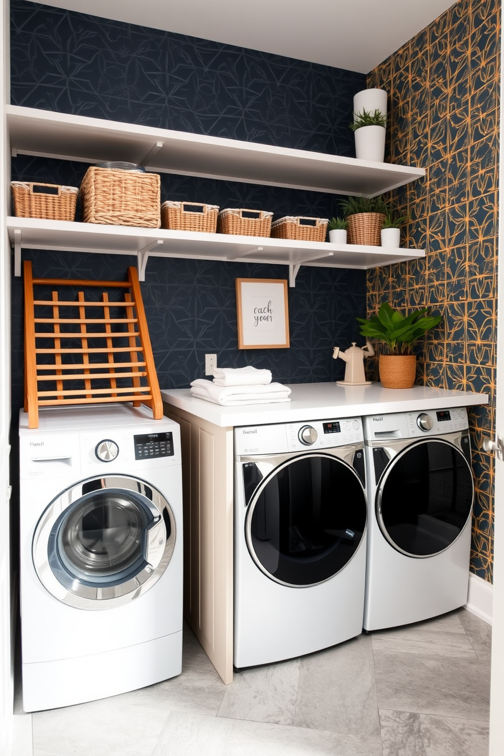 A vibrant laundry room features a bold wallpaper accent with a geometric pattern in shades of navy and gold. The space includes a sleek white countertop for folding clothes, with open shelves above displaying neatly organized baskets and decorative plants. To the left, a modern washer and dryer are stacked with a stylish wooden drying rack beside them. The floor is adorned with large format tiles in a soft gray, providing a clean and contemporary look.