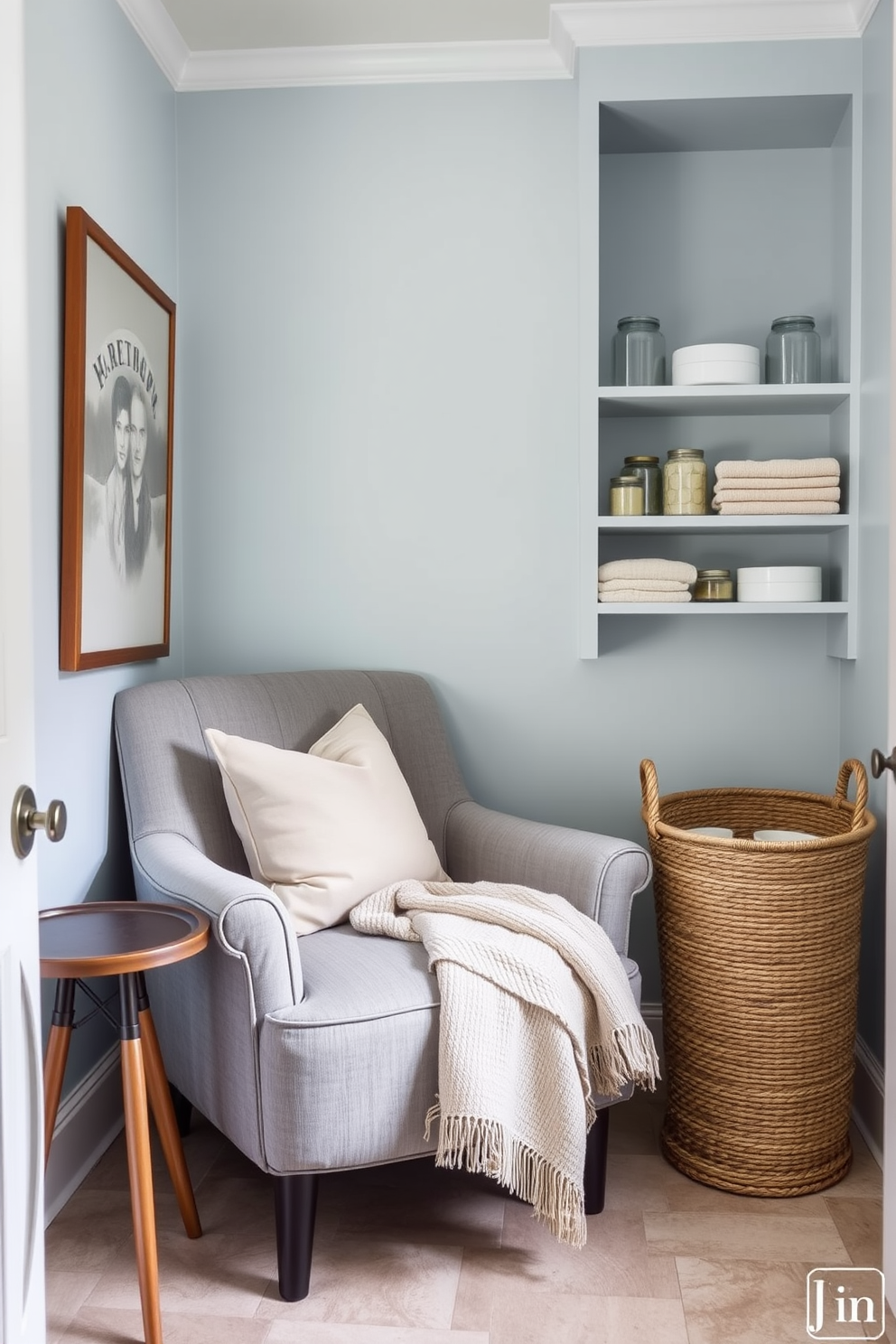 A cozy seating nook is designed with a plush, oversized armchair upholstered in soft gray fabric, accompanied by a small round side table. A warm throw blanket is draped over the armchair, and a few decorative pillows in muted tones add a touch of comfort. The walls of the laundry room are painted in a light, airy blue, creating a serene atmosphere. A stylish laundry basket made of woven rattan sits next to a set of open shelves displaying neatly folded towels and decorative jars.