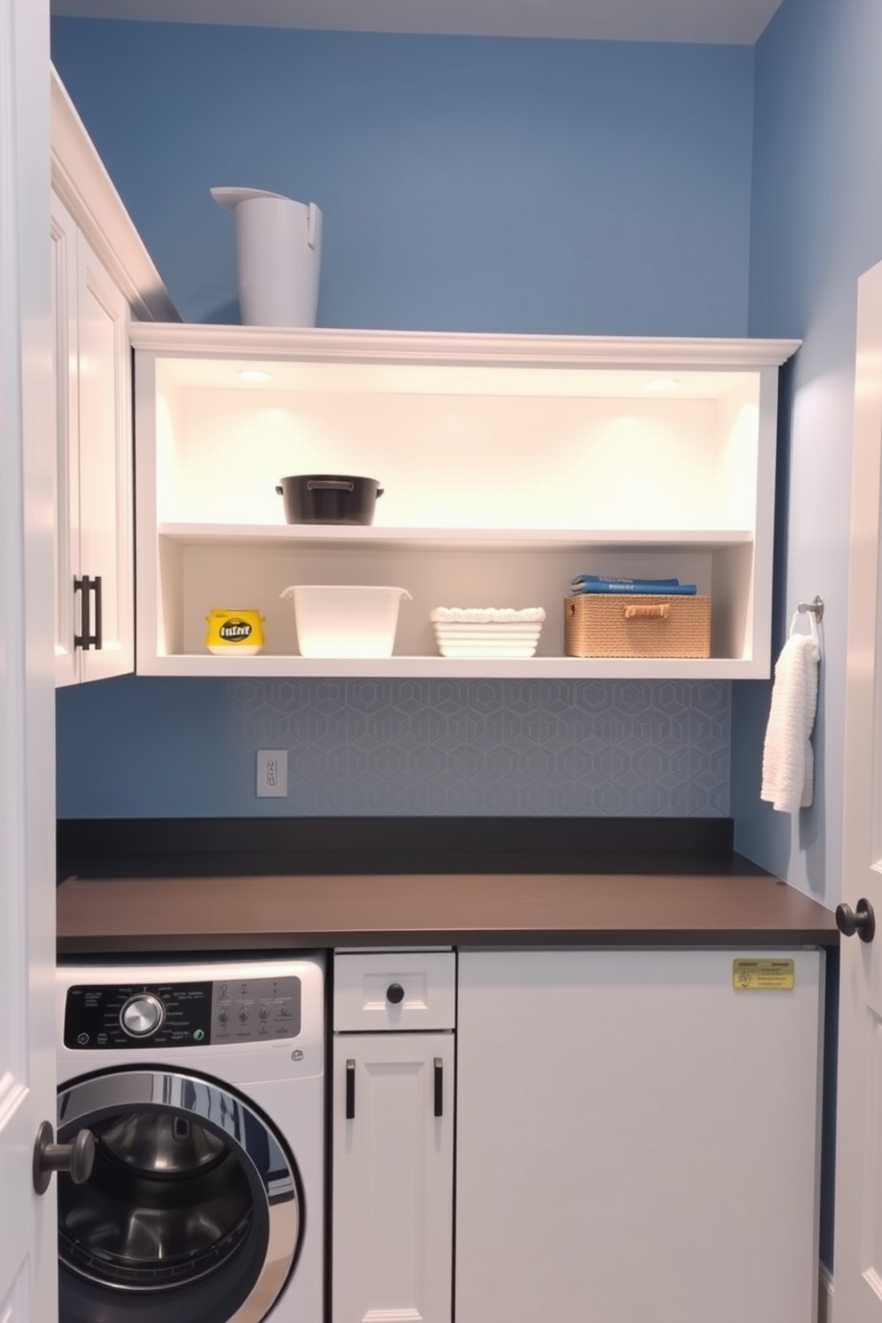 A bright and functional laundry room features open shelving above a sleek countertop for easy access to laundry essentials. The walls are painted in a soft blue hue, complemented by white cabinetry and a stylish backsplash in a geometric pattern.