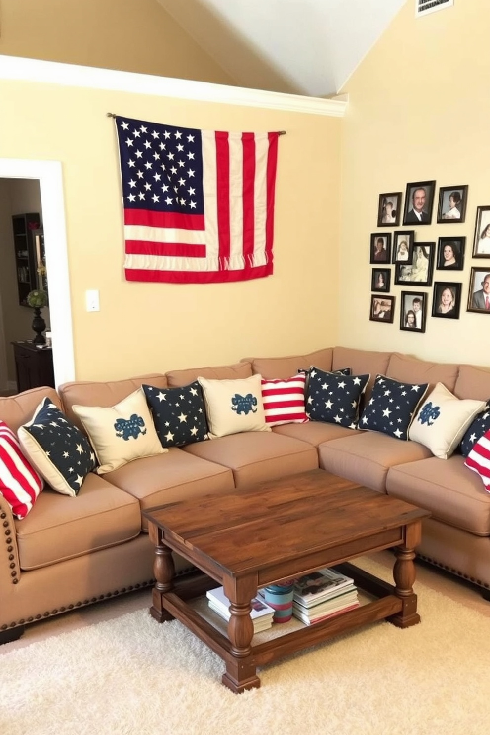 A cozy living room adorned with cushions featuring stars and stripes patterns. The cushions are arranged on a plush sectional sofa, complemented by a rustic wooden coffee table at the center. The walls are painted in a soft beige, creating a warm and inviting atmosphere. An American flag hangs artfully on one wall, while a collection of framed family photos adds a personal touch to the decor.