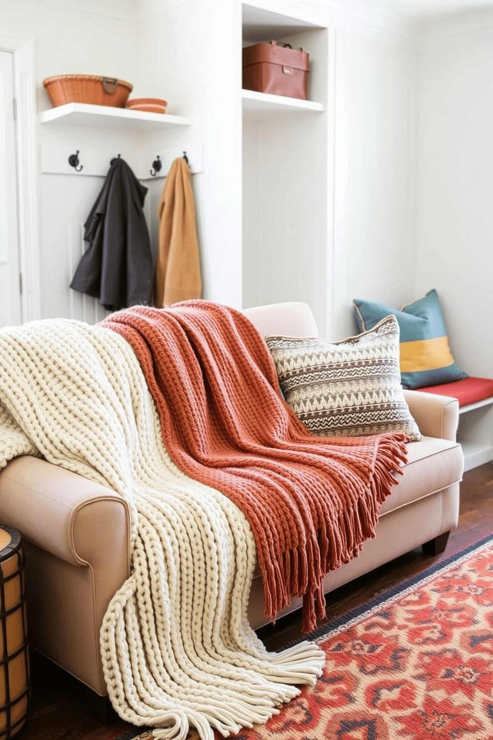 Cozy throw blankets for chilly days. Soft knitted textures in warm earth tones are draped over a plush sofa, inviting relaxation and comfort. Labor Day mudroom decorating ideas. A functional space features built-in benches with colorful cushions, hooks for jackets, and a stylish area rug that adds a pop of color.