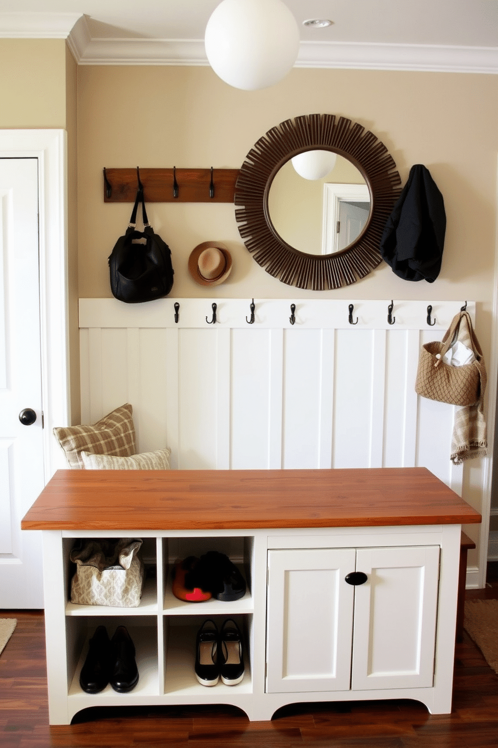 A functional mudroom island with seating features a spacious wooden top that serves as a drop zone for bags and shoes. Underneath, there are open cubbies for storage and a row of hooks on the wall for coats and hats. The decor includes a cozy bench with soft cushions and a large decorative mirror above the island. Warm tones and natural materials create an inviting atmosphere, perfect for a busy family's entryway.