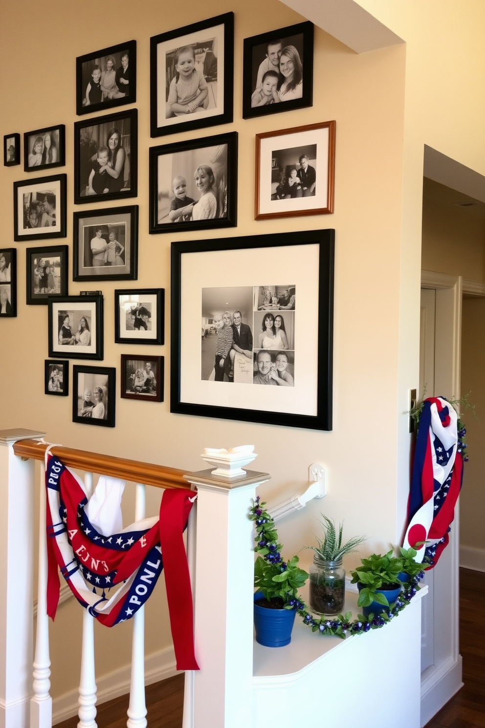 A gallery wall displays a curated collection of family photos in various frames, arranged in a visually appealing layout. The wall features a mix of black and white images alongside colorful snapshots, creating a warm and inviting atmosphere. The staircase is adorned with seasonal decorations for Labor Day, featuring red, white, and blue accents. Banners and garlands drape elegantly along the railing, complemented by small potted plants to enhance the festive look.