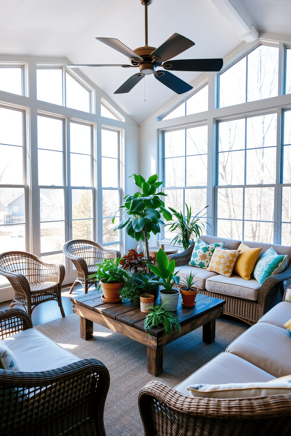 A bright and airy sunroom features large windows that allow natural light to flood the space. A comfortable seating area is arranged with a mix of wicker chairs and a plush sofa adorned with colorful cushions. In the center of the room, a rustic wooden coffee table holds a collection of vibrant potted plants. A ceiling fan hangs from the ceiling, providing a gentle breeze and enhancing the relaxed atmosphere of the sunroom.