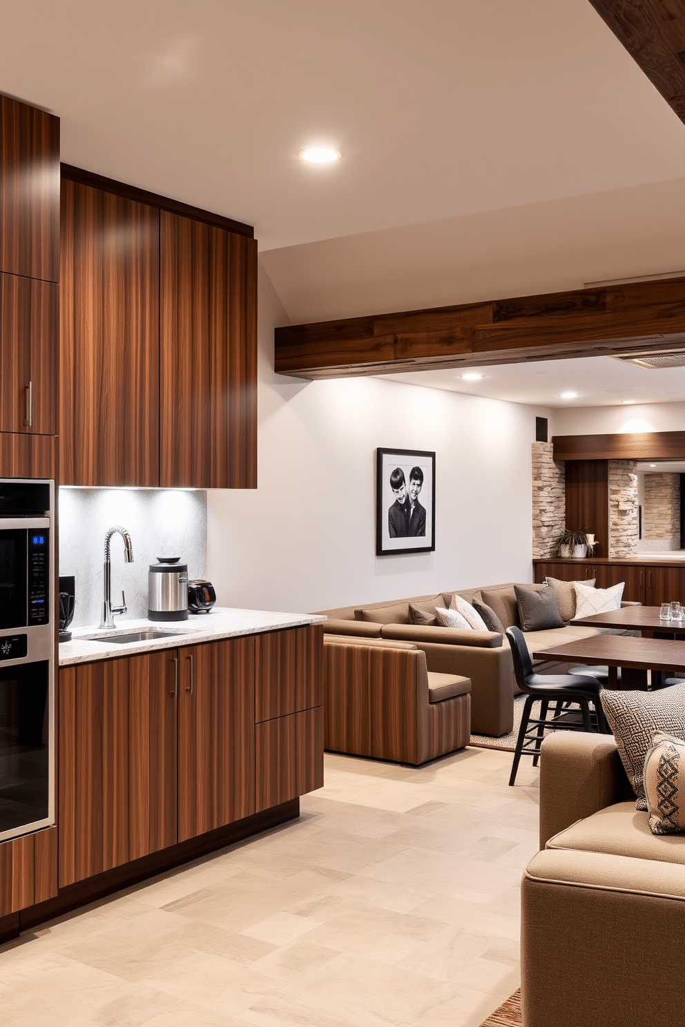 A contemporary kitchenette designed for entertaining guests features sleek cabinetry in a rich walnut finish, complemented by a large island with a polished quartz countertop. Under-cabinet lighting highlights the modern appliances and creates an inviting atmosphere for social gatherings. The large basement design incorporates a cozy lounge area with plush sectional sofas and a built-in bar with stylish stools. Warm, ambient lighting and a mix of textured materials, such as reclaimed wood and stone accents, enhance the space's inviting and functional appeal.