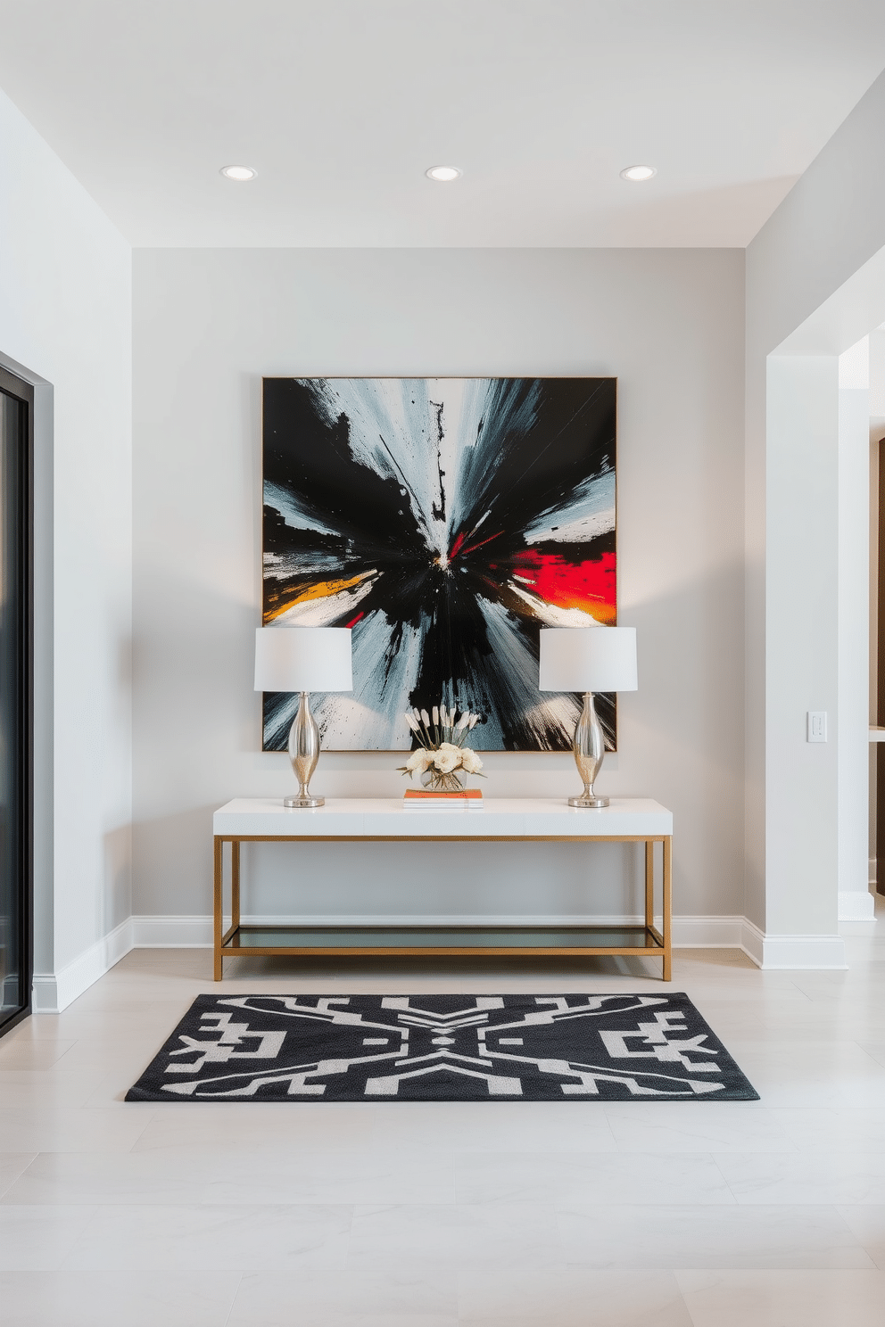 A spacious entryway features a stunning modern art piece as the focal point, positioned prominently against a sleek, neutral-colored wall. The floor is adorned with a geometric patterned rug, and a stylish console table, flanked by decorative lamps, adds an inviting touch to the space.