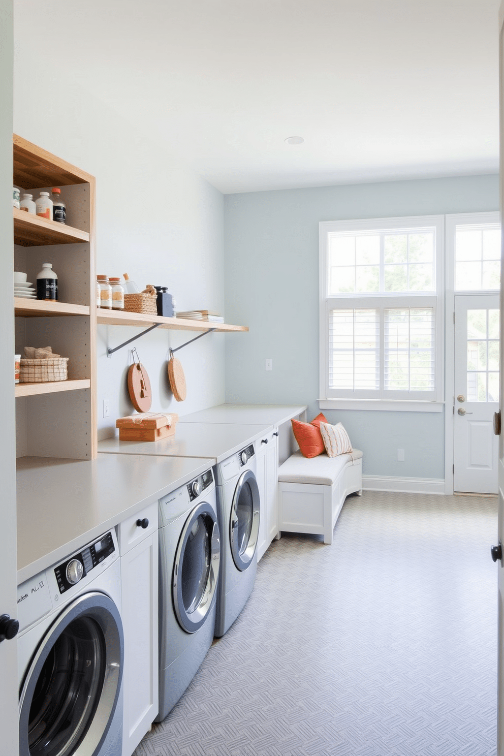 A spacious laundry room features open shelving along one wall, providing easy access to frequently used items like detergents and fabric softeners. The shelves are made of reclaimed wood, adding a rustic charm to the modern design, while a large countertop for folding clothes runs parallel beneath the windows, allowing natural light to flood the space. The room is painted in a soft, calming blue, creating a serene atmosphere for laundry tasks. A stylish, durable tile floor in a herringbone pattern complements the overall aesthetic, and a cozy seating area with a small bench invites relaxation during laundry day.