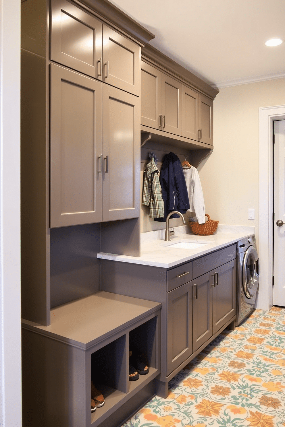 Integrated laundry area with folding station. This space features a sleek, built-in cabinetry with ample storage, a countertop for folding clothes, and a large sink for hand-washing delicate items. Large mudroom design ideas. The mudroom includes a spacious bench with built-in hooks for coats, cubbies for shoes, and a vibrant, patterned tile floor that adds a pop of color to the functional space.