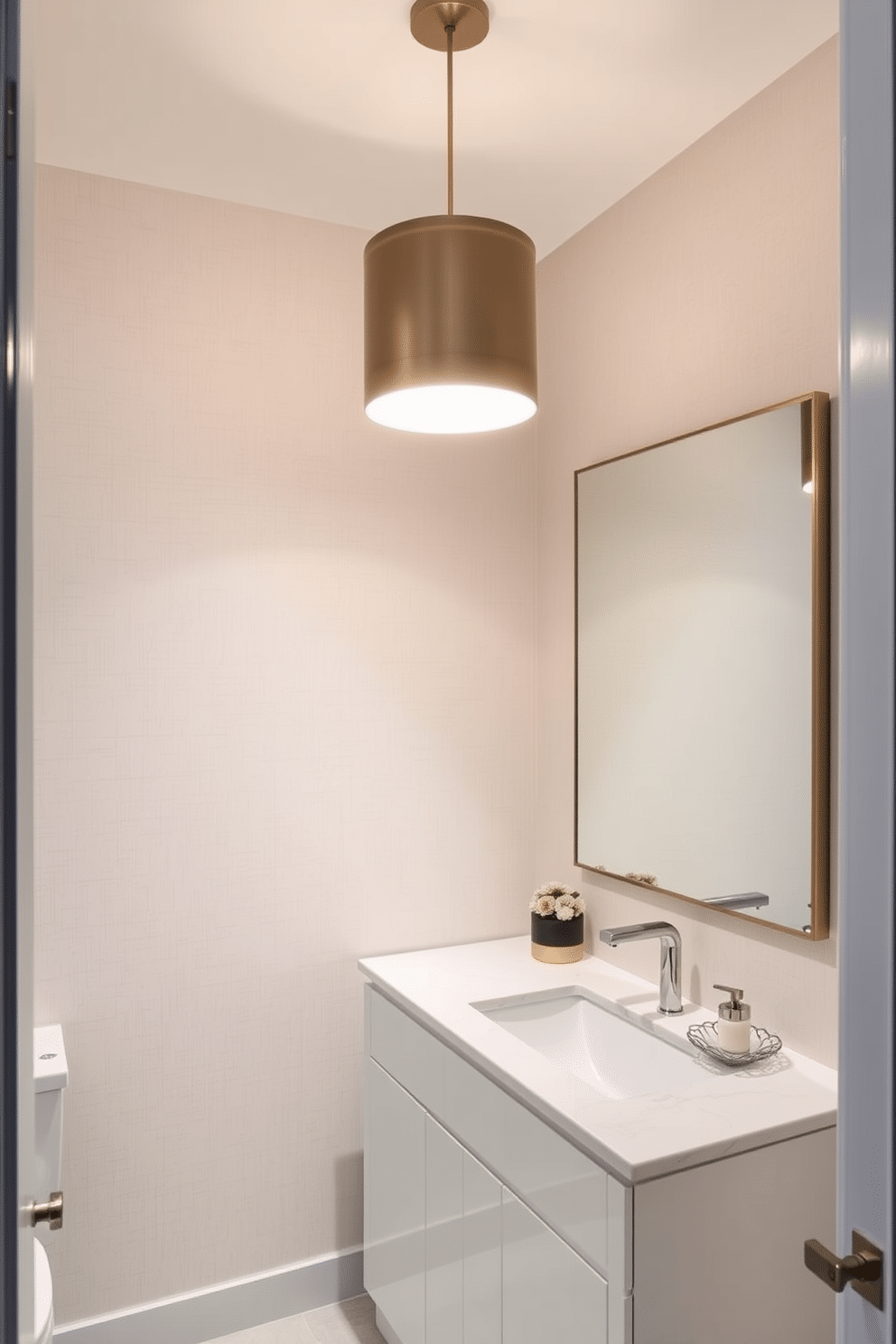 A stylish powder room featuring a statement pendant light that hangs gracefully from the ceiling, illuminating the space with a warm glow. The walls are adorned with a sleek, textured wallpaper in a soft neutral tone, complementing the elegant fixtures. The large powder room includes a contemporary vanity with a glossy finish and a spacious countertop, providing ample space for decorative accessories. A large mirror with a minimalist frame reflects the chic lighting, enhancing the room's modern aesthetic.