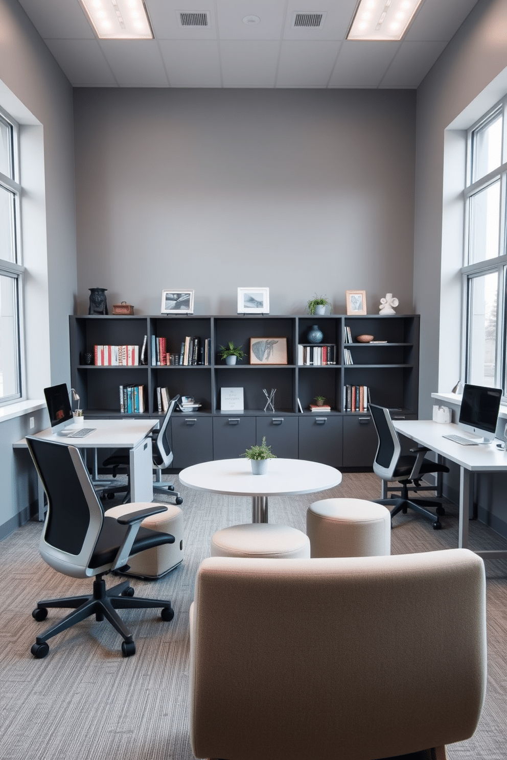 A spacious study room designed for collaboration features dual workstations, each equipped with modern ergonomic chairs and sleek, minimalist desks. The walls are painted a soft gray, complemented by large windows that allow natural light to flood the space, enhancing productivity and creativity. In the center of the room, a round table with comfortable seating encourages brainstorming sessions and teamwork. Shelves filled with books and decorative items line the walls, adding personality and warmth to the environment.