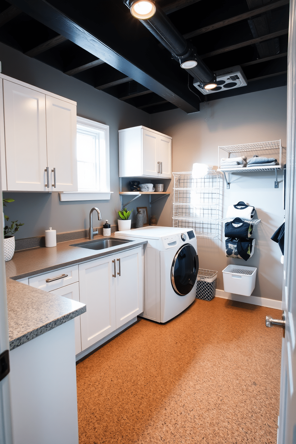 A cozy laundry room in the basement features warm cork flooring that adds both comfort and durability. The space is designed with sleek, white cabinetry and a large sink for easy washing, complemented by a stylish countertop for folding clothes. Natural light pours in through a small window, illuminating the room and enhancing the inviting atmosphere. To the side, a wall-mounted drying rack and organized storage solutions keep the area tidy and functional.