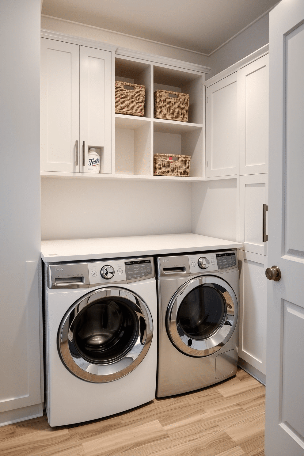 A modern laundry room featuring open cubbies for quick organization, allowing easy access to essentials like detergents and fabric softeners. The walls are painted a soft gray, and the floor is adorned with a durable, water-resistant laminate that mimics wood. The cabinetry incorporates sleek, minimalist lines with a combination of open shelving and closed storage for a clean look. A stylish countertop above the washer and dryer provides additional workspace, while decorative baskets add texture and functionality to the open cubbies.