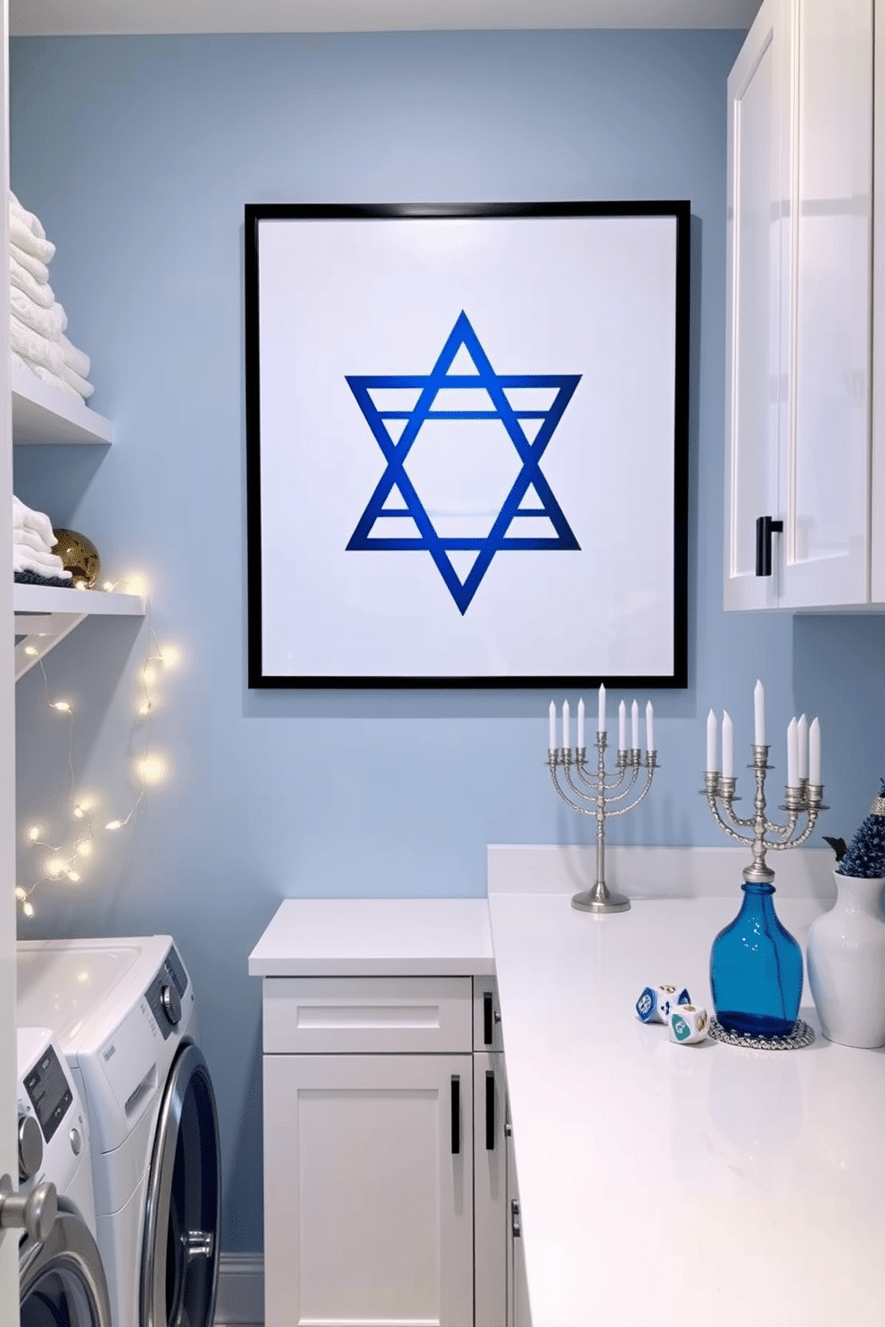 A serene laundry room featuring a large Star of David wall art piece, elegantly framed in a modern black frame. The walls are painted a soft blue, complemented by sleek white cabinetry and a spacious countertop for folding clothes. For Hanukkah, the room is adorned with subtle decorations, including a string of warm white fairy lights draped along the shelves. A decorative menorah sits on the countertop, surrounded by colorful dreidels and festive blue and silver accents.