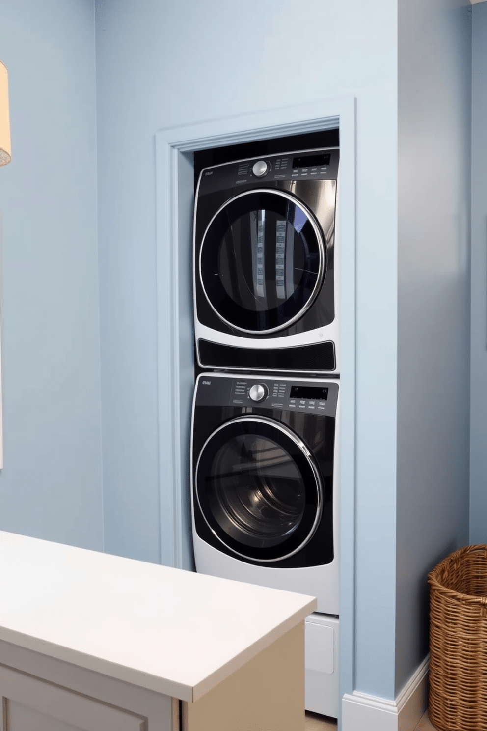 A stylish laundry room featuring a stacked washer and dryer setup, framed by decorative tiles that add visual interest to the space. The walls are painted in a soft blue hue, complemented by a sleek countertop for folding clothes, and a wicker basket for storage sits nearby.