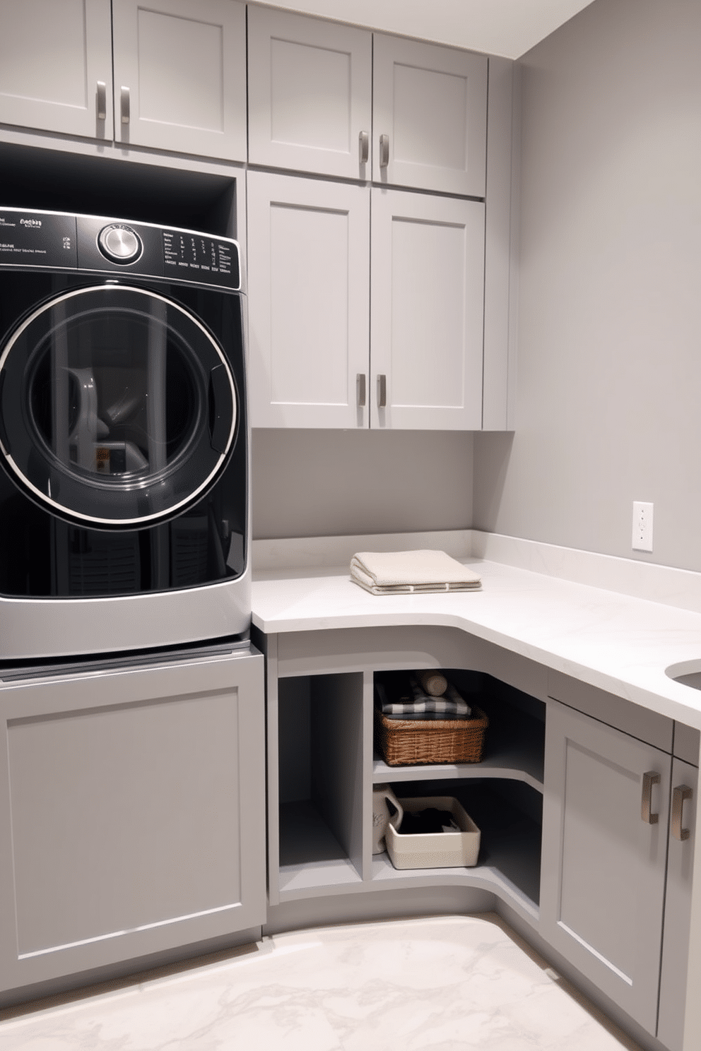 A functional laundry room featuring a spacious countertop designed for folding clothes conveniently. The space includes a stacked washer and dryer unit, maximizing vertical storage while maintaining a sleek, modern aesthetic. The walls are painted in a soft gray, creating a calm and inviting atmosphere. Underneath the countertop, open shelving provides easy access to laundry supplies, while a stylish basket adds an element of organization.