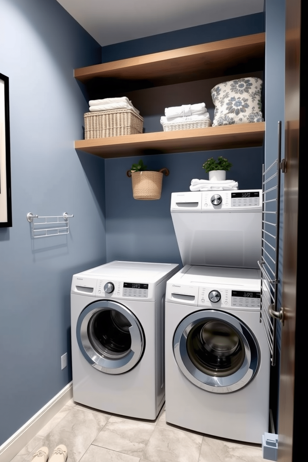 A cozy laundry room nook features stacked units with a sleek, modern design. The walls are painted in a soft blue hue, and the floor is covered with light gray tiles that create a clean and airy feel. Above the stacked washer and dryer, open shelving displays neatly folded towels and decorative baskets. A small potted plant adds a touch of greenery, while a stylish wall-mounted drying rack is installed nearby for convenience.