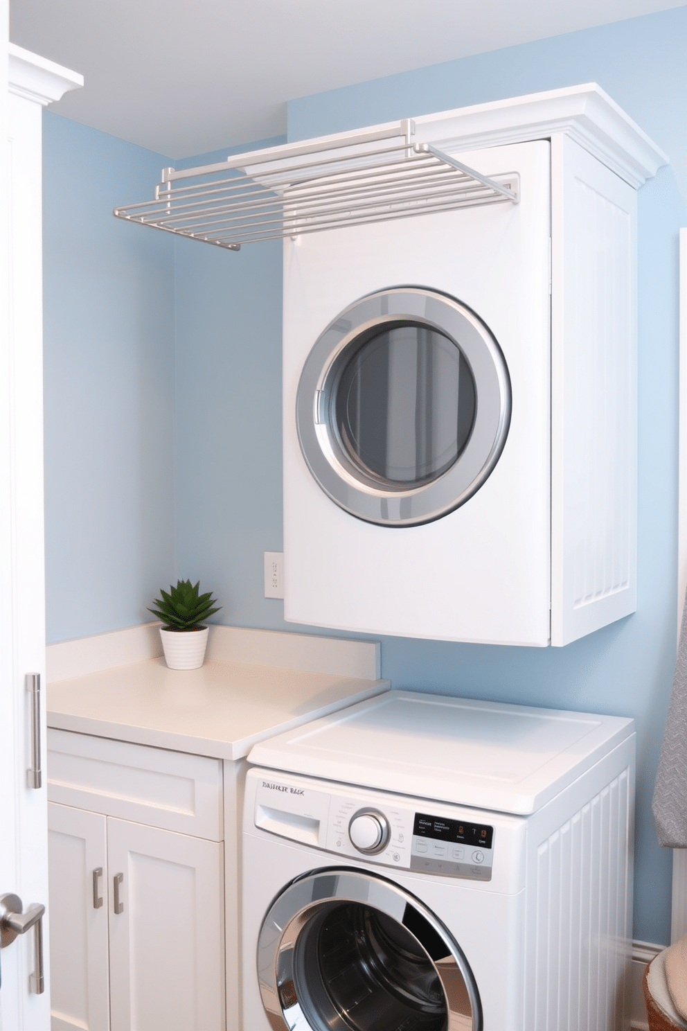 A modern laundry room featuring a stacked washer and dryer setup, maximizing space efficiency. Above the machines, a sleek drying rack is installed, providing convenience for air-drying clothes. The walls are painted in a soft, calming blue, complemented by white cabinetry that offers ample storage. A stylish countertop extends beside the machines, ideal for folding laundry, while a small potted plant adds a touch of greenery to the space.