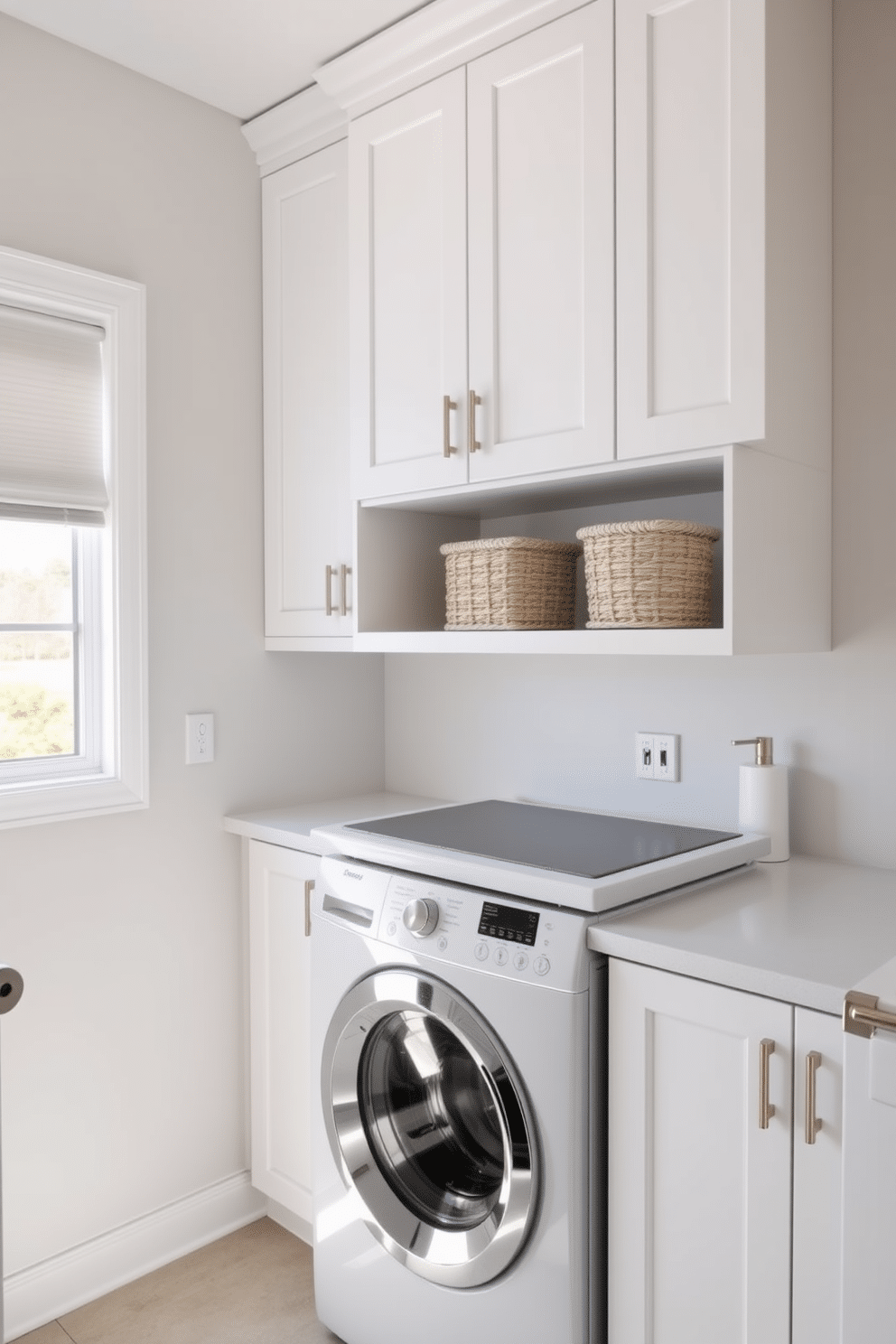 A modern laundry room featuring sleek, polished fixtures and a top-loading washer seamlessly integrated into the cabinetry. The space is brightened by natural light streaming in through a large window, highlighting the minimalist design and organized layout. The cabinetry is finished in a crisp white, complemented by brushed nickel hardware for a contemporary touch. A stylish countertop above the washer provides ample space for folding clothes, while decorative baskets add a functional yet chic element to the design.