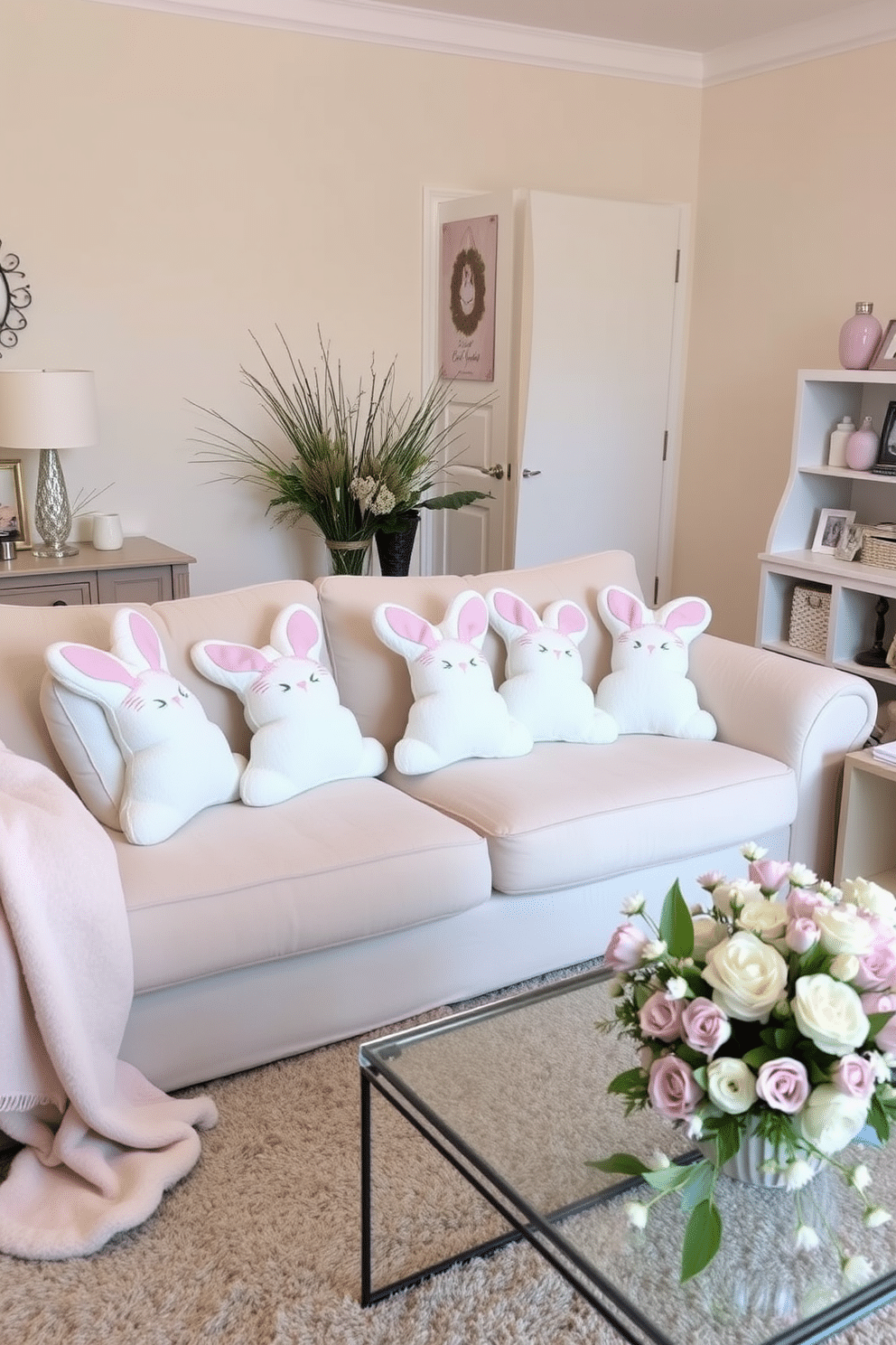 A cozy living room adorned for Easter, featuring bunny-shaped cushions scattered across a plush, light-colored sofa. The room is decorated with pastel-colored accents, including a soft throw blanket and a floral centerpiece on the coffee table.