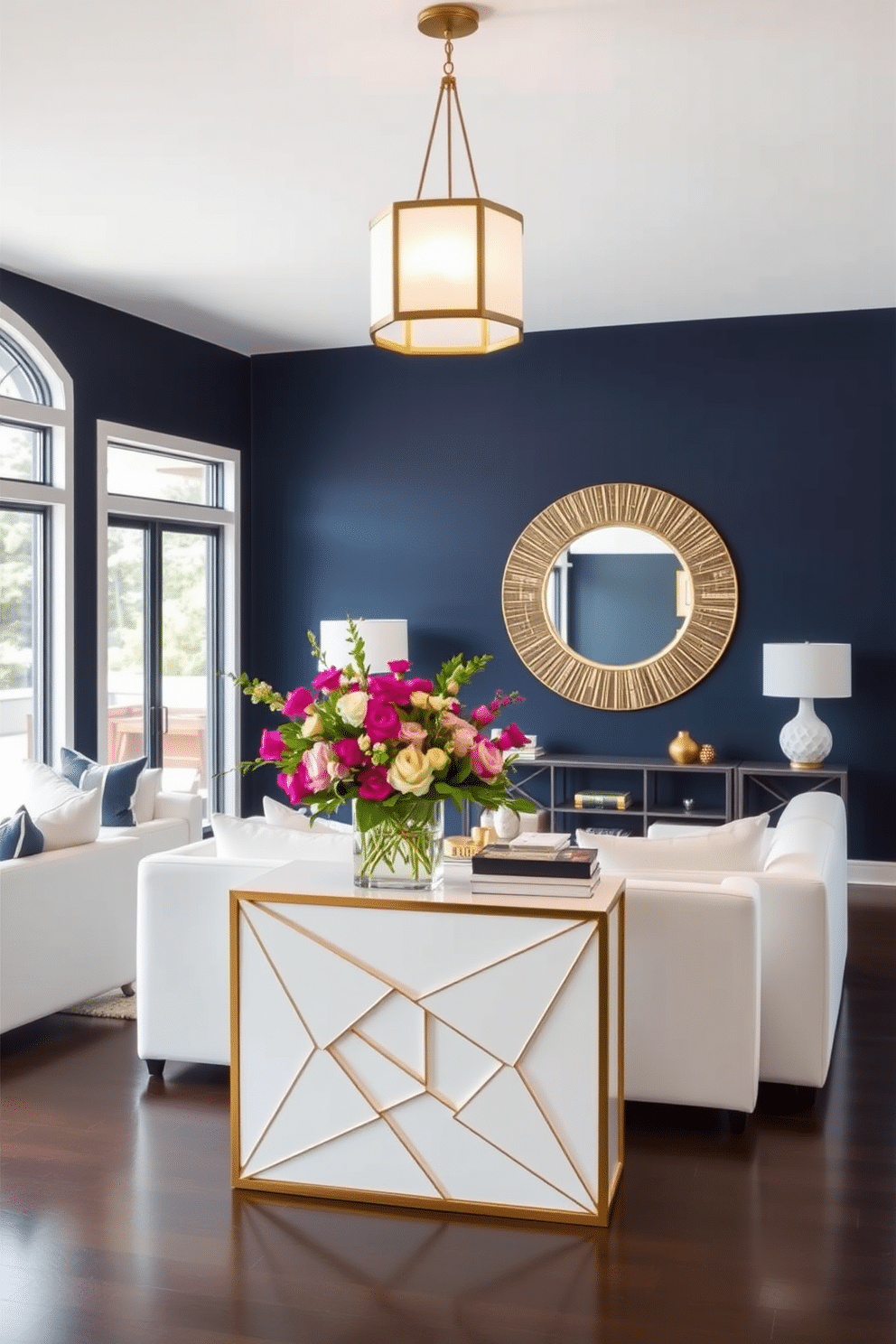 A striking accent wall painted in a deep navy blue serves as the focal point of the living room, enhancing the modern aesthetic of the space. Complementing the wall, sleek white furniture pieces and gold accents create a sophisticated atmosphere, while large windows allow natural light to flood the room. The entryway features a stylish console table with a geometric design, topped with a vibrant arrangement of fresh flowers. A round mirror with a decorative frame hangs above the table, reflecting the warm glow of a nearby pendant light that illuminates the space beautifully.