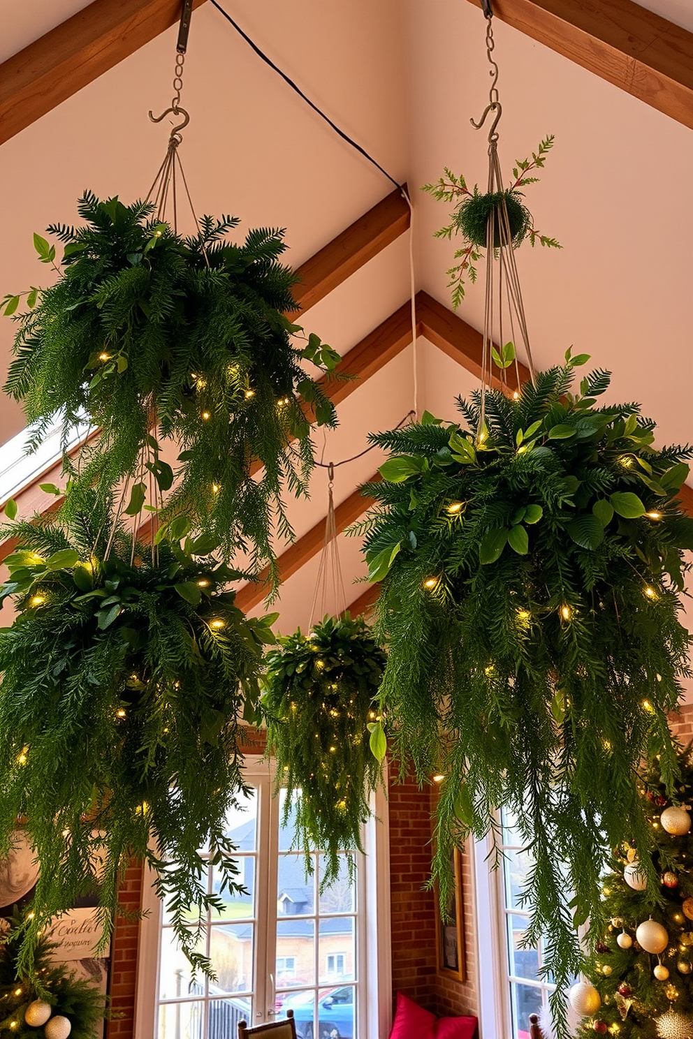 A cozy loft adorned for Christmas, featuring hanging greenery from ceiling hooks that cascade down in lush arrangements. Twinkling fairy lights weave through the foliage, creating a warm and inviting atmosphere throughout the space.