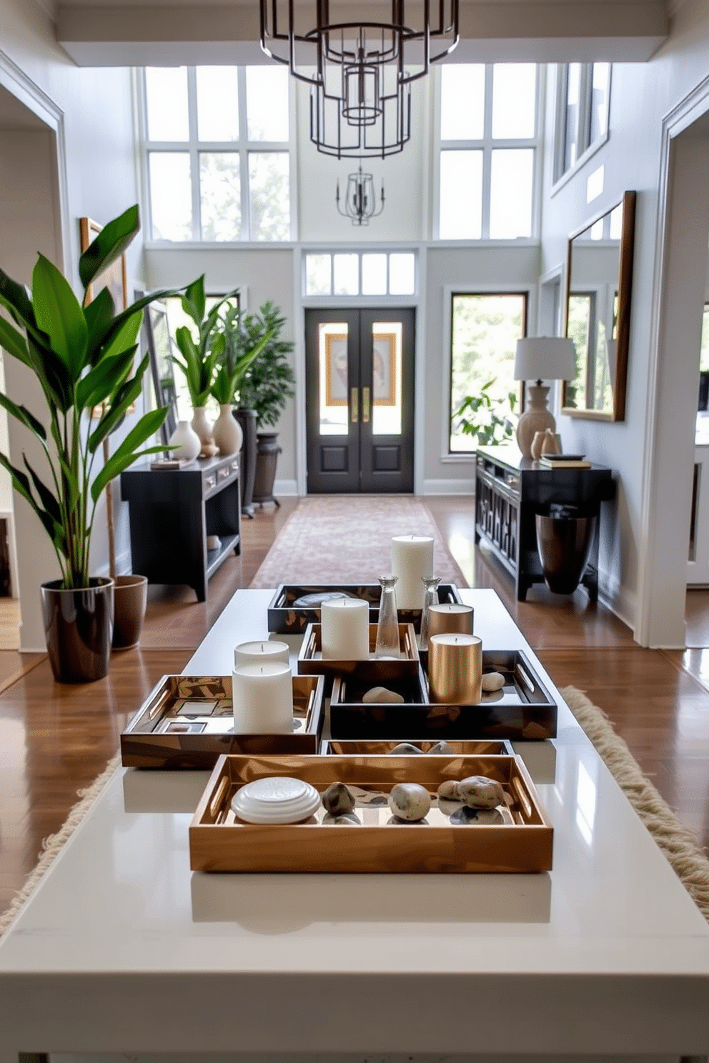 A collection of decorative trays in varying sizes and materials, beautifully arranged on a sleek console table. The trays are filled with curated small items such as candles, coasters, and decorative stones, adding both style and functionality to the space. A long foyer featuring an elegant runner rug that guides guests into the home. Flanking the entrance are tall potted plants and framed artwork, creating a welcoming atmosphere filled with natural light from large windows.