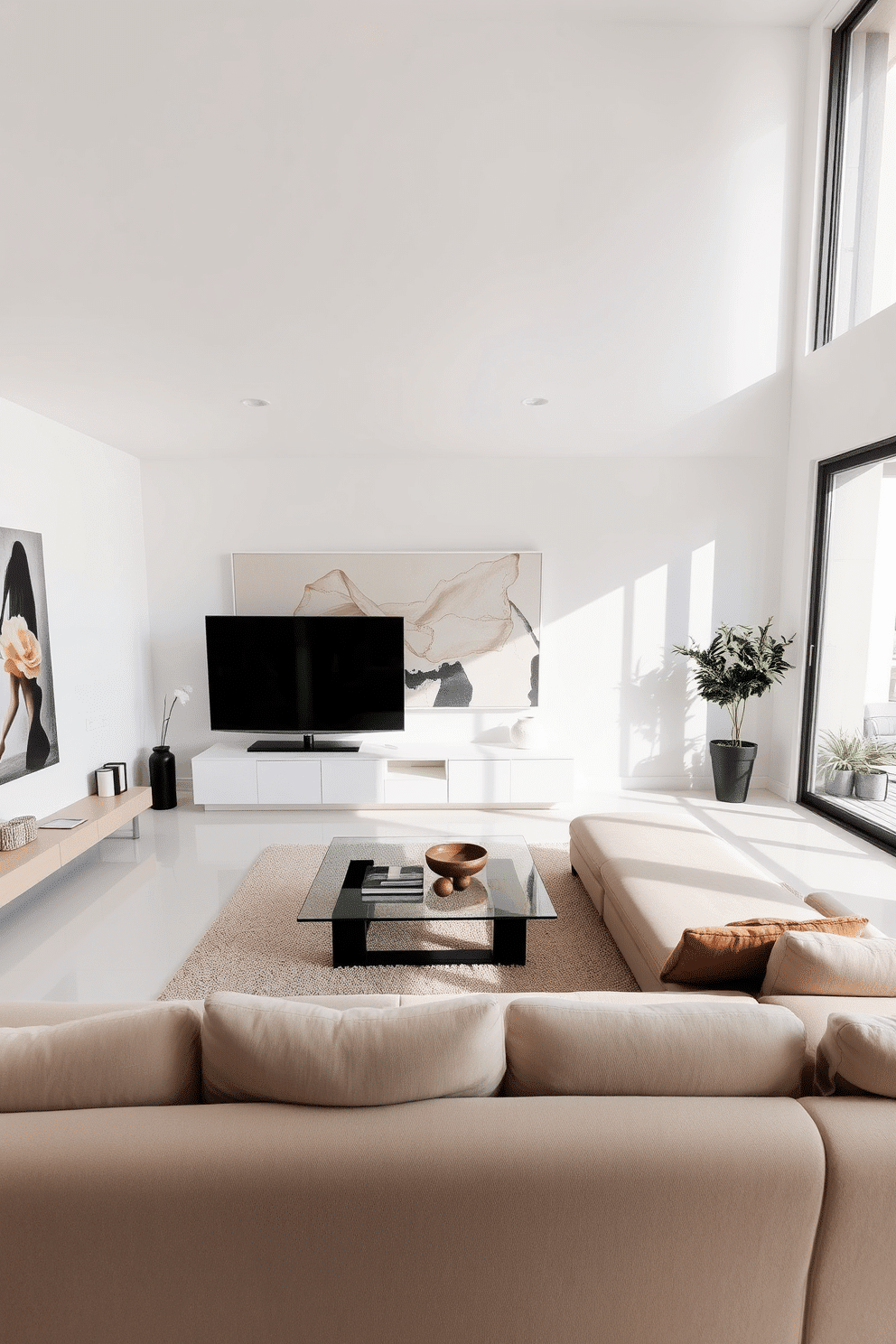 A modern minimalist family room featuring sleek lines and an open layout. The space is adorned with a low-profile sectional sofa in a neutral color, complemented by a glass coffee table and a large, abstract artwork on the wall. Natural light floods the room through floor-to-ceiling windows, highlighting the simplicity of the decor. A minimalist entertainment unit holds a flat-screen TV, while a few carefully selected decorative items add a touch of warmth without cluttering the space.