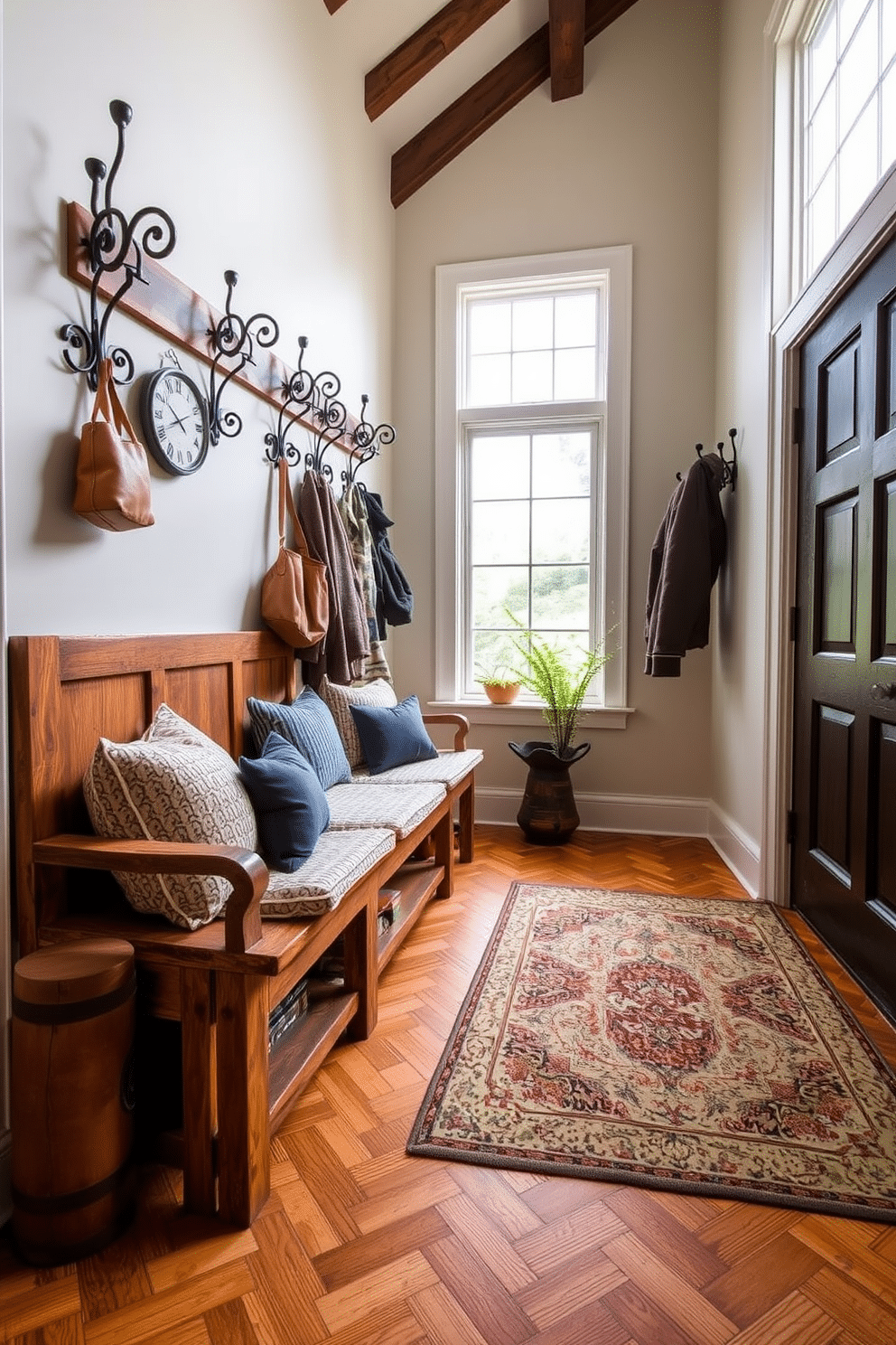 A vintage-inspired mudroom features a rustic wooden bench with plush cushions, creating a welcoming space for relaxation. Elegant vintage hooks line the walls, crafted from wrought iron, perfect for hanging coats and bags, adding character to the design. The flooring is a classic herringbone pattern in warm tones, complemented by a large area rug that provides comfort underfoot. Natural light floods the room through a large window, illuminating the space and highlighting the charming decor elements.