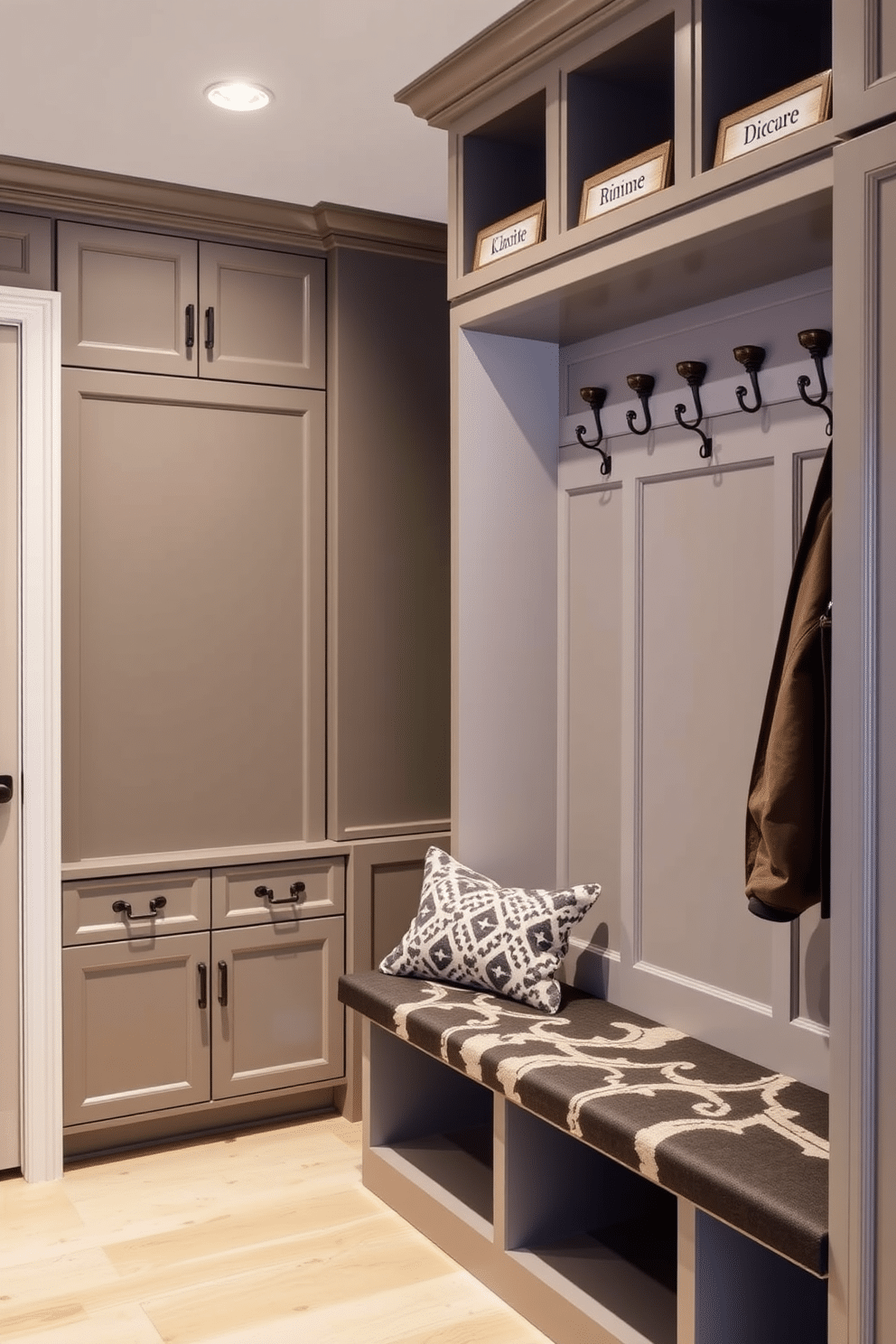 A luxury mudroom features personalized name tags elegantly displayed on custom hooks, adding a personal touch to the space. The design includes built-in cabinetry with ample storage, paired with a stylish bench for convenience and comfort.