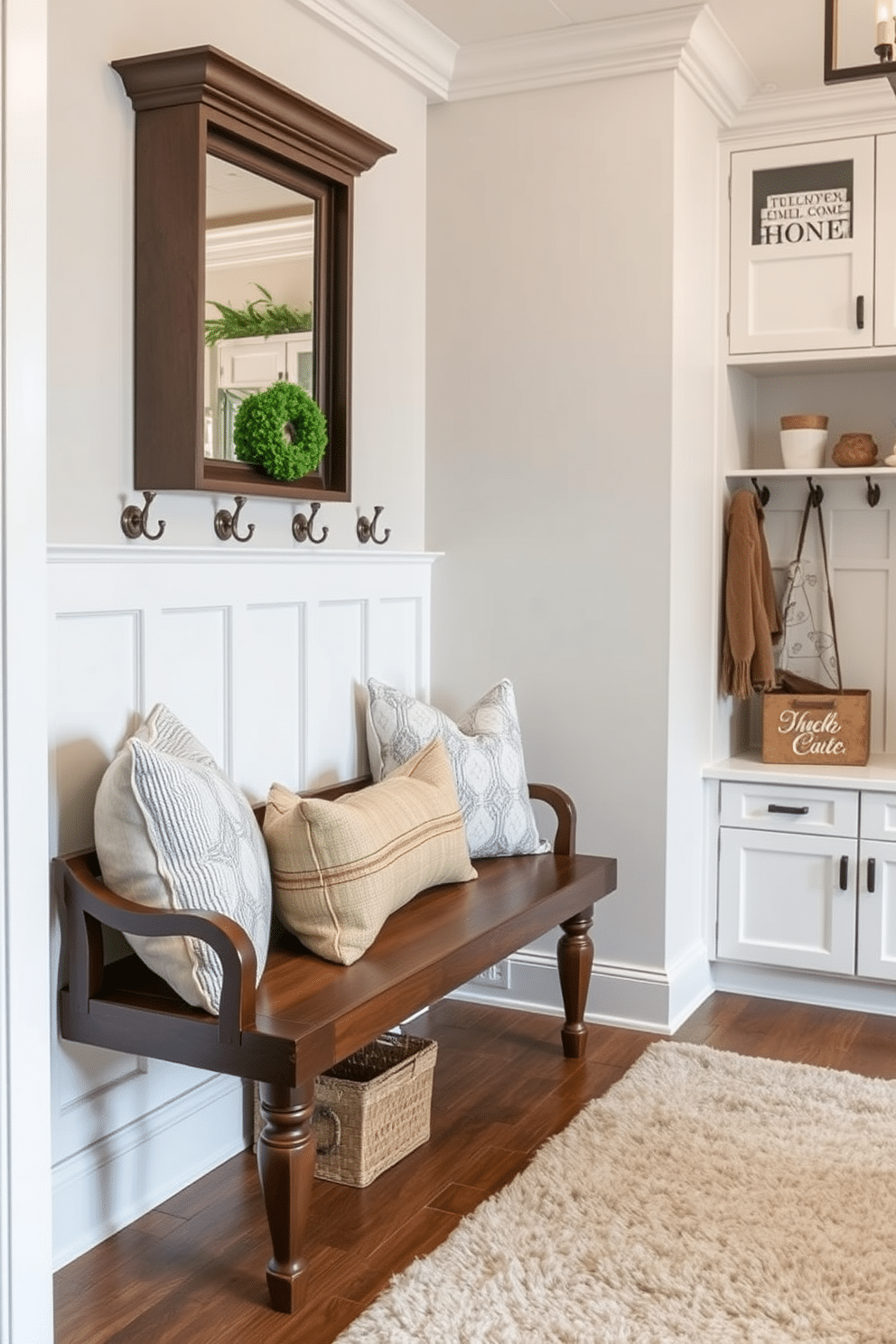 A stylish bench with decorative pillows is positioned against a wall, creating a welcoming entryway. The bench features a rich wood finish, complemented by a variety of textured pillows in soft, neutral tones. The luxury mudroom boasts ample storage solutions, including built-in cabinetry and cubbies for organization. Elegant hooks line the walls, adorned with seasonal decor, while a plush area rug adds warmth underfoot.