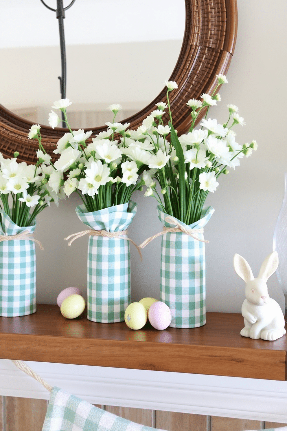 A charming mantel adorned for Easter features gingham fabric wrapped vases filled with fresh spring flowers. The vases are artfully arranged alongside pastel-colored decorative eggs and a delicate bunny figurine, creating a festive and inviting atmosphere.