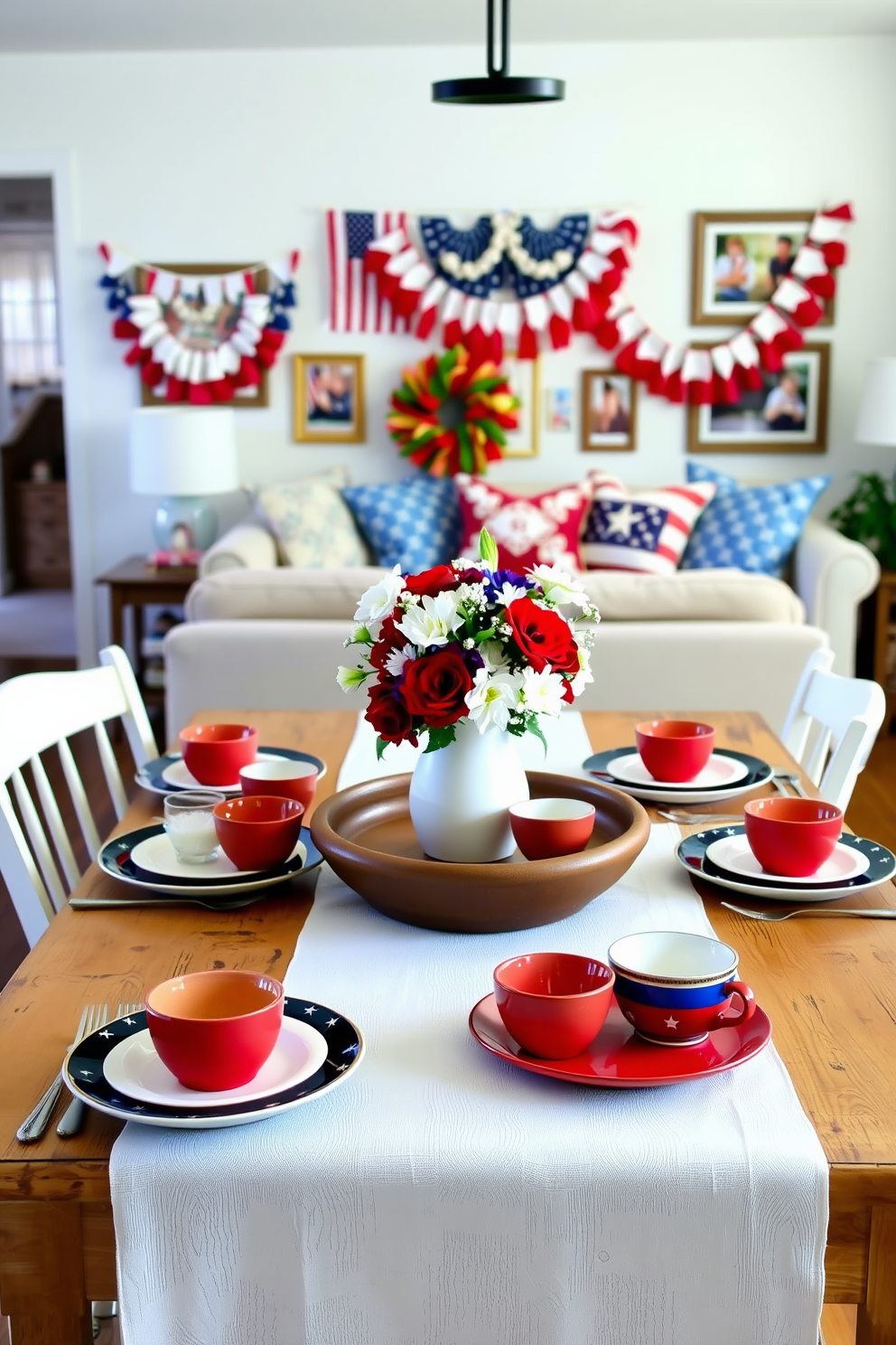 A charming dining setup featuring a red, white, and blue dishware set is arranged on a rustic wooden table. The table is adorned with a crisp white tablecloth and a centerpiece of fresh flowers in patriotic colors. In the background, a cozy living area showcases festive decorations, including bunting and cushions in red and blue tones. The walls are decorated with framed photographs from past Memorial Day celebrations, adding a personal touch to the space.