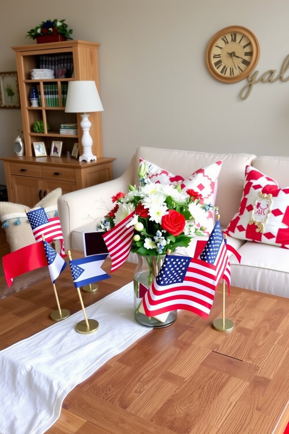 A festive tabletop display featuring small flags in red white and blue colors. The flags are arranged on a rustic wooden table adorned with a white tablecloth and complemented by seasonal decorations. Charming Memorial Day apartment decor showcasing patriotic elements. The living space includes a mix of red white and blue cushions on the sofa along with a centerpiece of flowers in a flag-themed vase.