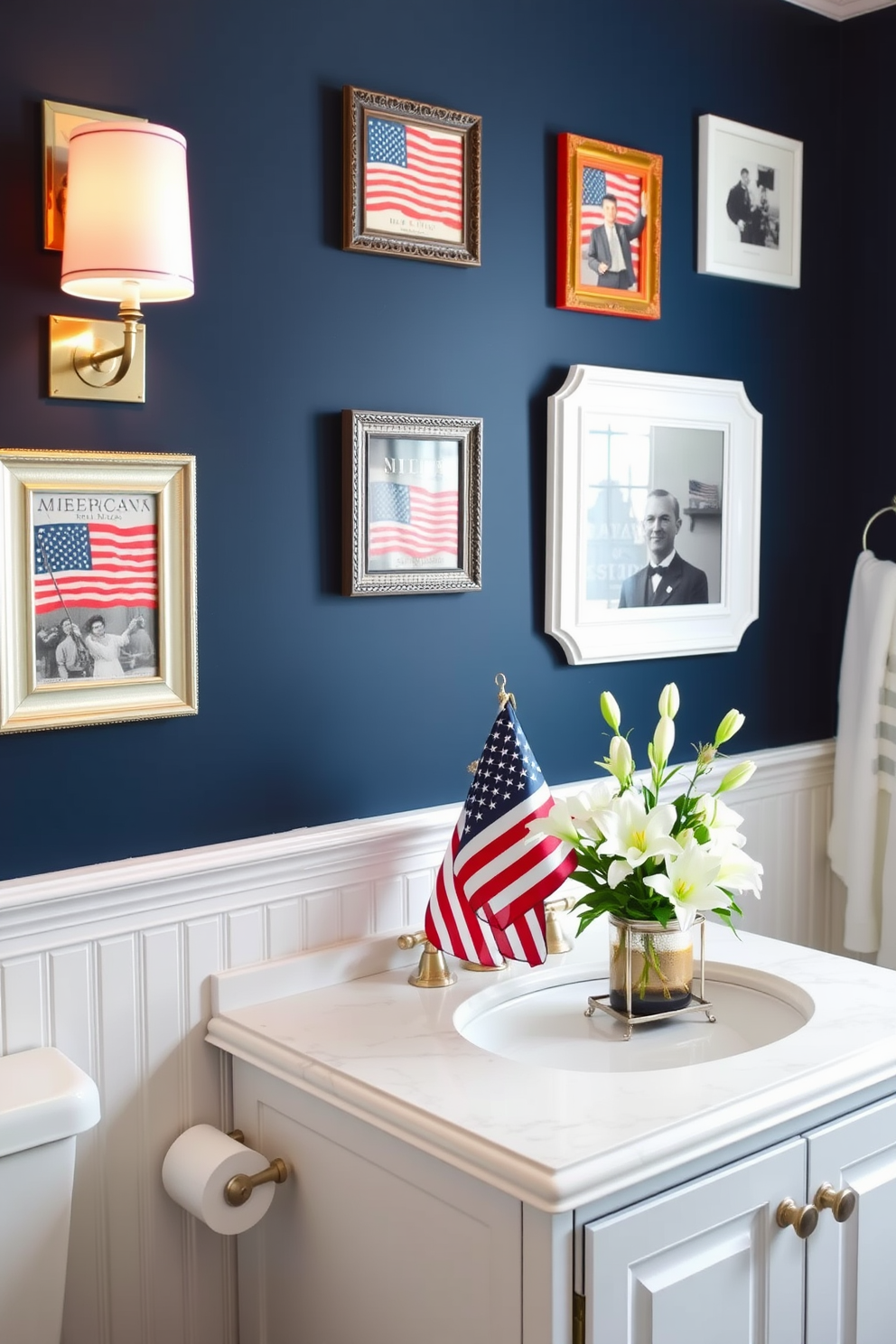 A cozy bathroom adorned with patriotic-themed picture frames. The frames are in red, white, and blue, showcasing vintage American flags and historical moments, hung on a navy blue accent wall above a white wainscoting. Celebrate Memorial Day with elegant bathroom decor. A white vanity with a marble countertop features red and blue candles, while a small American flag stands in a decorative holder beside a vase of fresh white lilies.