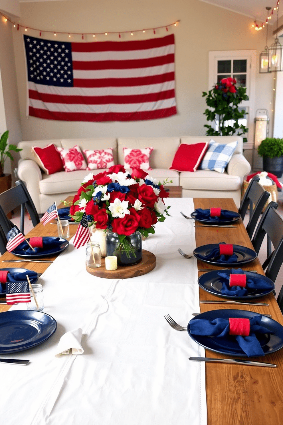 A Memorial Day-themed table setting. A large wooden table is adorned with a crisp white tablecloth, featuring a centerpiece of red, white, and blue flowers in a rustic vase. Each place setting includes a navy blue plate, a white napkin with a red napkin ring, and silver cutlery. Small American flags are placed in clear glass jars, and patriotic-themed candles are scattered around the table. The backdrop includes a string of red, white, and blue bunting, creating a festive and cohesive look. Memorial Day decorating ideas. The living room is decorated with red, white, and blue throw pillows on a neutral-colored sofa, enhancing the patriotic theme. A large American flag hangs prominently on one wall, serving as a focal point. The coffee table features a decorative tray with star-shaped candles and a small bouquet of patriotic flowers. Outdoor spaces are adorned with string lights and lanterns in patriotic colors, creating a warm and inviting atmosphere for evening gatherings.