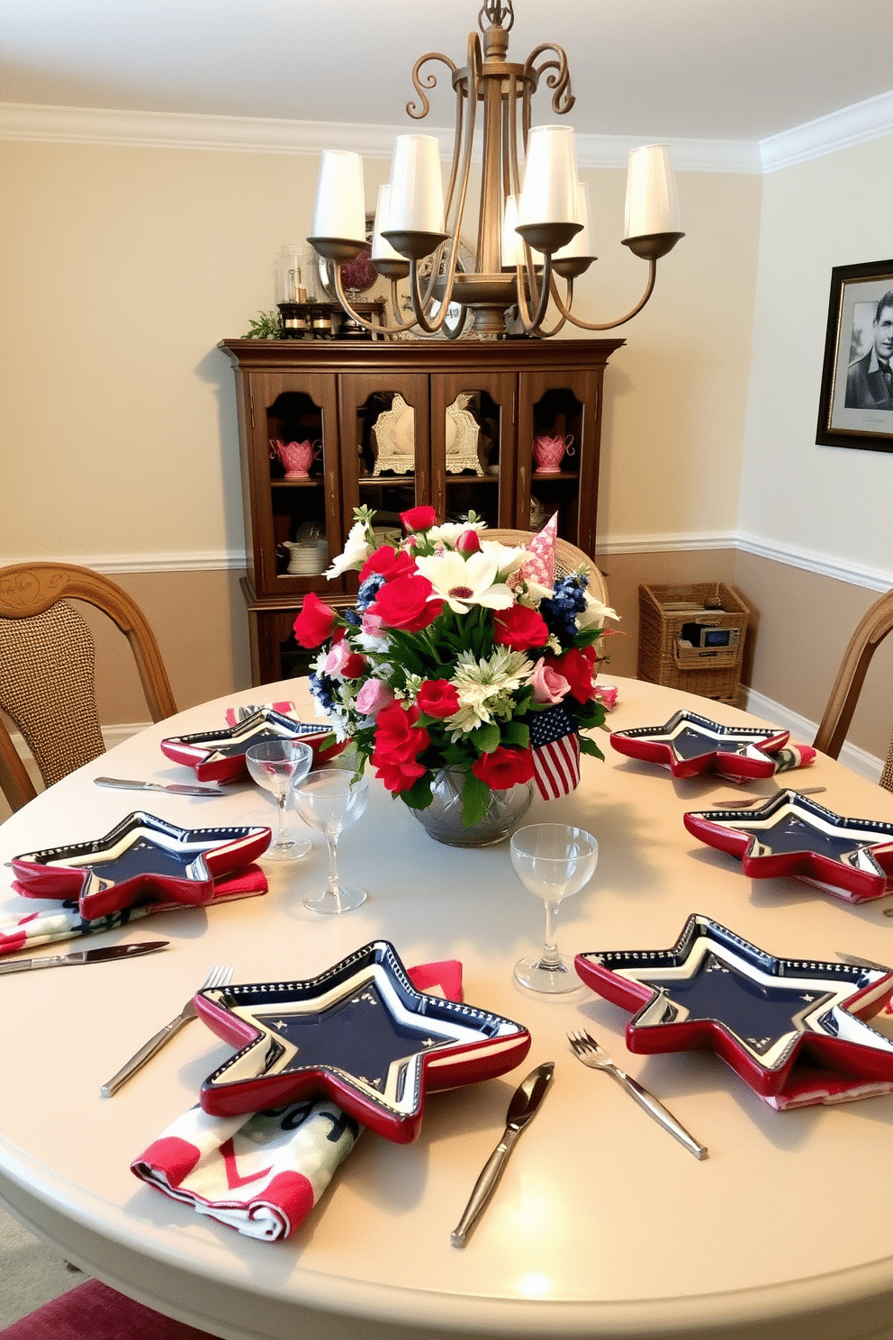 A cozy dining room set for Memorial Day celebrations. The table is adorned with ceramic dishes shaped like stars, each painted in a mix of red, white, and blue. Patriotic-themed napkins are neatly folded beside the place settings, and a centerpiece of fresh flowers in coordinating colors sits in the middle of the table. The room is softly lit by a chandelier, casting a warm glow over the festive decor.