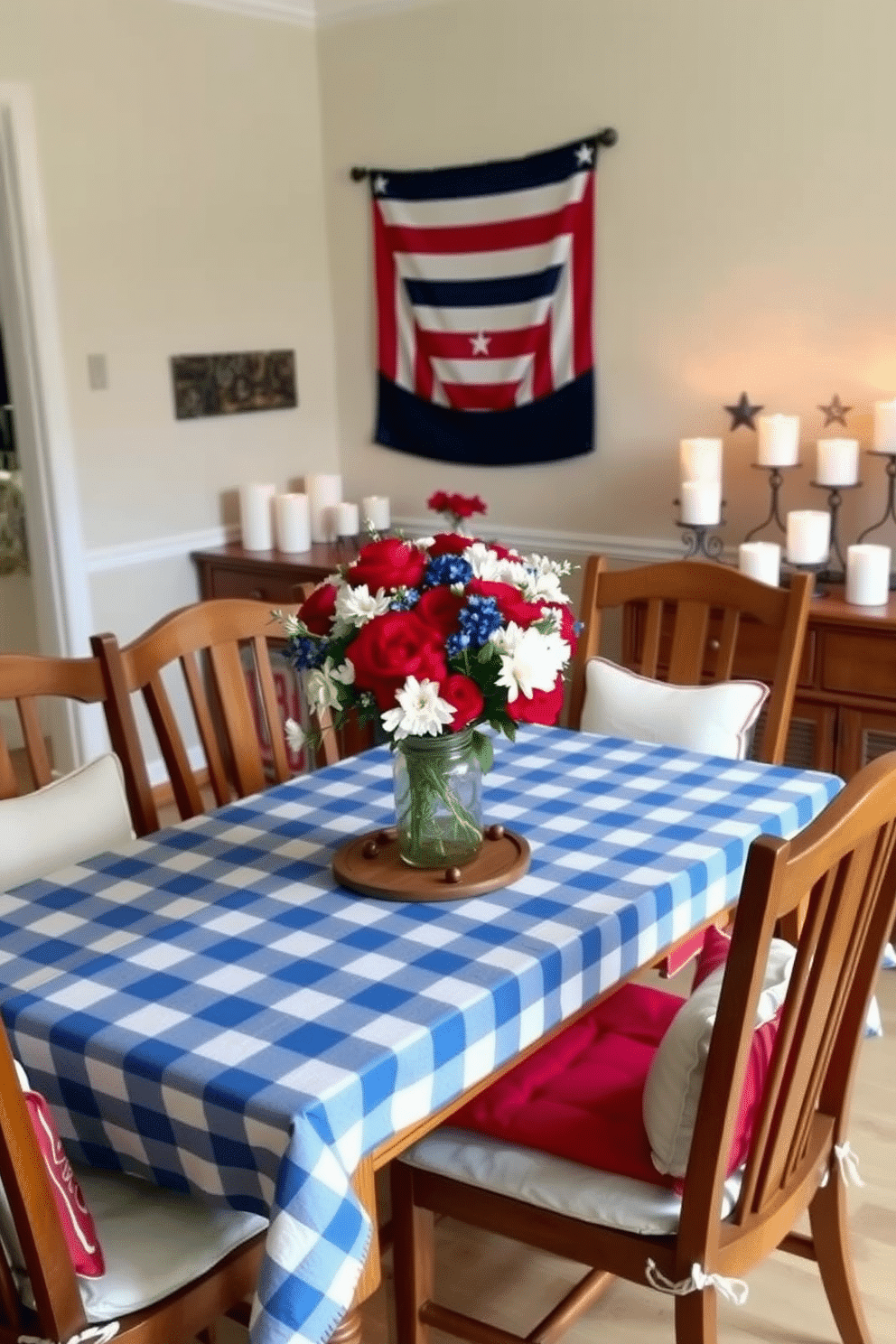 A cozy dining room set for Memorial Day. The table is adorned with a blue and white checkered tablecloth, upon which a centerpiece of red, white, and blue flowers sits in a rustic mason jar. Surrounding the table are wooden chairs with comfortable cushions in patriotic colors. On the wall behind the table, a decorative banner with stars and stripes adds a festive touch, while a sideboard holds an assortment of star-shaped candles, casting a warm and inviting glow.