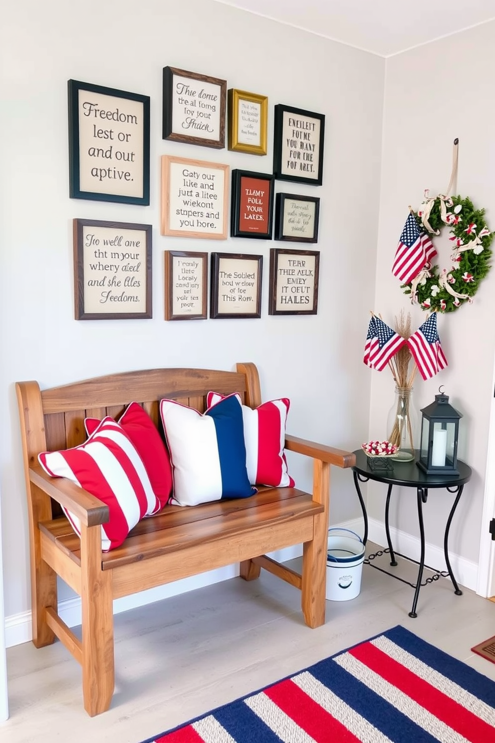 A welcoming entryway decorated for Memorial Day. A rustic wooden bench is placed against the wall, adorned with red, white, and blue throw pillows. Above the bench, a gallery wall features framed quotes about freedom, each in a different stylish font. To the right, a small table holds a vase filled with American flags and a decorative lantern. The floor is covered with a striped rug in patriotic colors, and a wreath made of small American flags hangs on the front door.