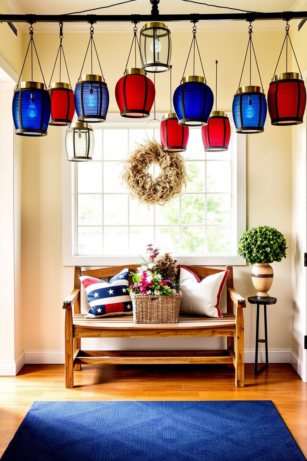 An inviting entryway adorned with hanging lanterns in red, white, and blue, creating a festive Memorial Day atmosphere. The lanterns are arranged at varying heights, casting a warm glow over a rustic wooden bench below. Patriotic-themed pillows in matching colors are placed on the bench, alongside a woven basket filled with fresh flowers. The walls are painted a soft cream, complementing a navy blue rug that anchors the space.