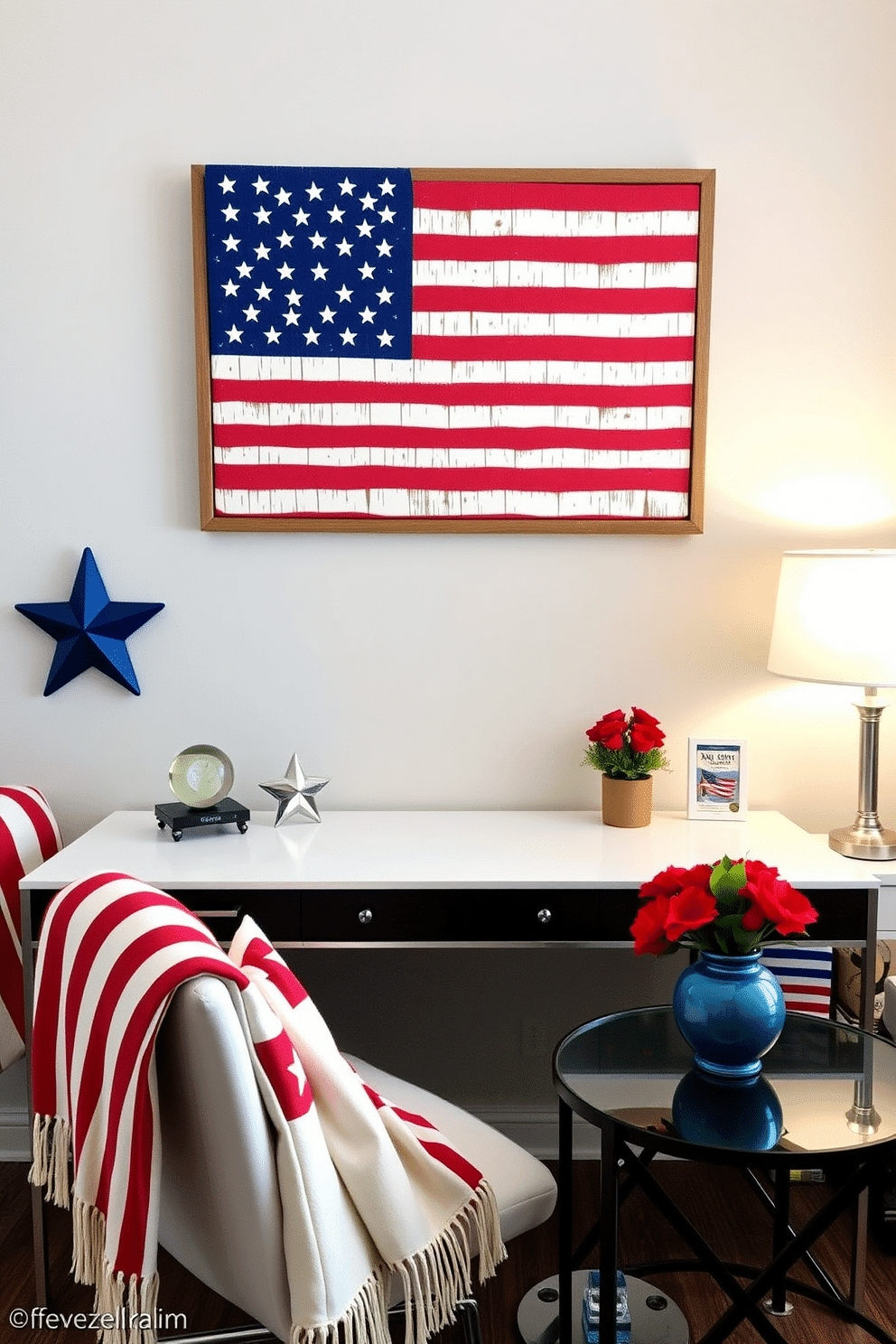 A patriotic flag wall art display features a large American flag canvas framed in rustic wood, prominently hung above a sleek modern desk. The desk is adorned with red, white, and blue accents, including a star-shaped paperweight and a small potted plant. For Memorial Day home office decorating ideas, incorporate subtle patriotic elements such as a themed throw blanket draped over the chair and decorative cushions featuring stars and stripes. A small table arrangement with red flowers in a blue vase adds a festive touch while maintaining a professional atmosphere.