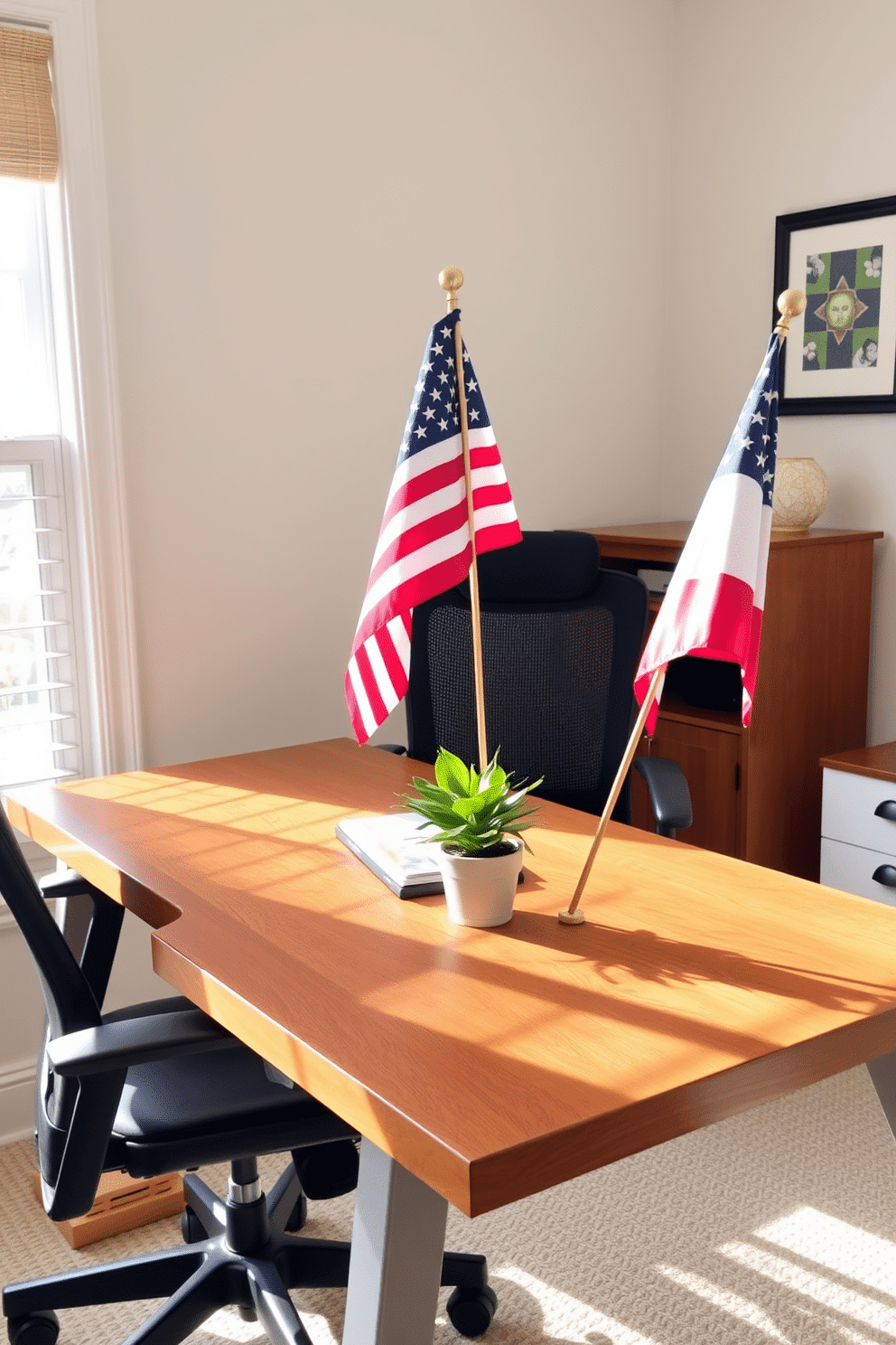 Decorative flags are placed in the corners of a stylish home office desk, adding a festive touch to the workspace. The desk features a sleek design with a warm wood finish, complemented by a comfortable ergonomic chair and bright natural light streaming in from a nearby window. The walls are adorned with patriotic-themed art, enhancing the Memorial Day spirit. A small potted plant sits beside the flags, bringing a touch of greenery to the decor and creating a welcoming atmosphere.